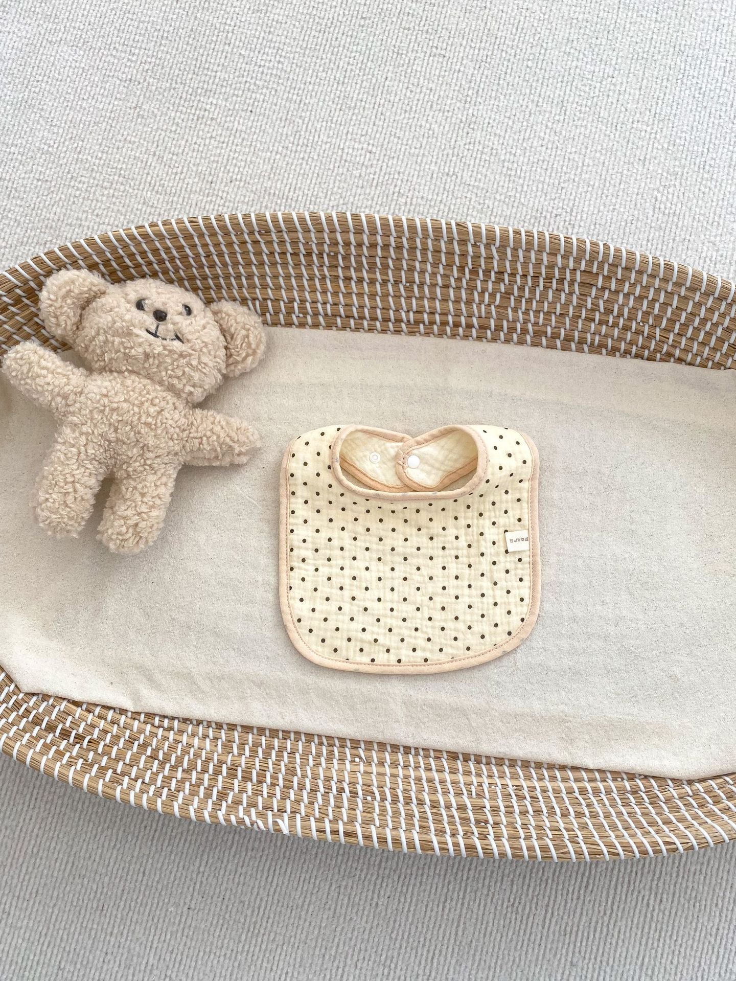 Adorable U-shaped cotton muslin bib featuring cute cartoon designs, perfect for babies.