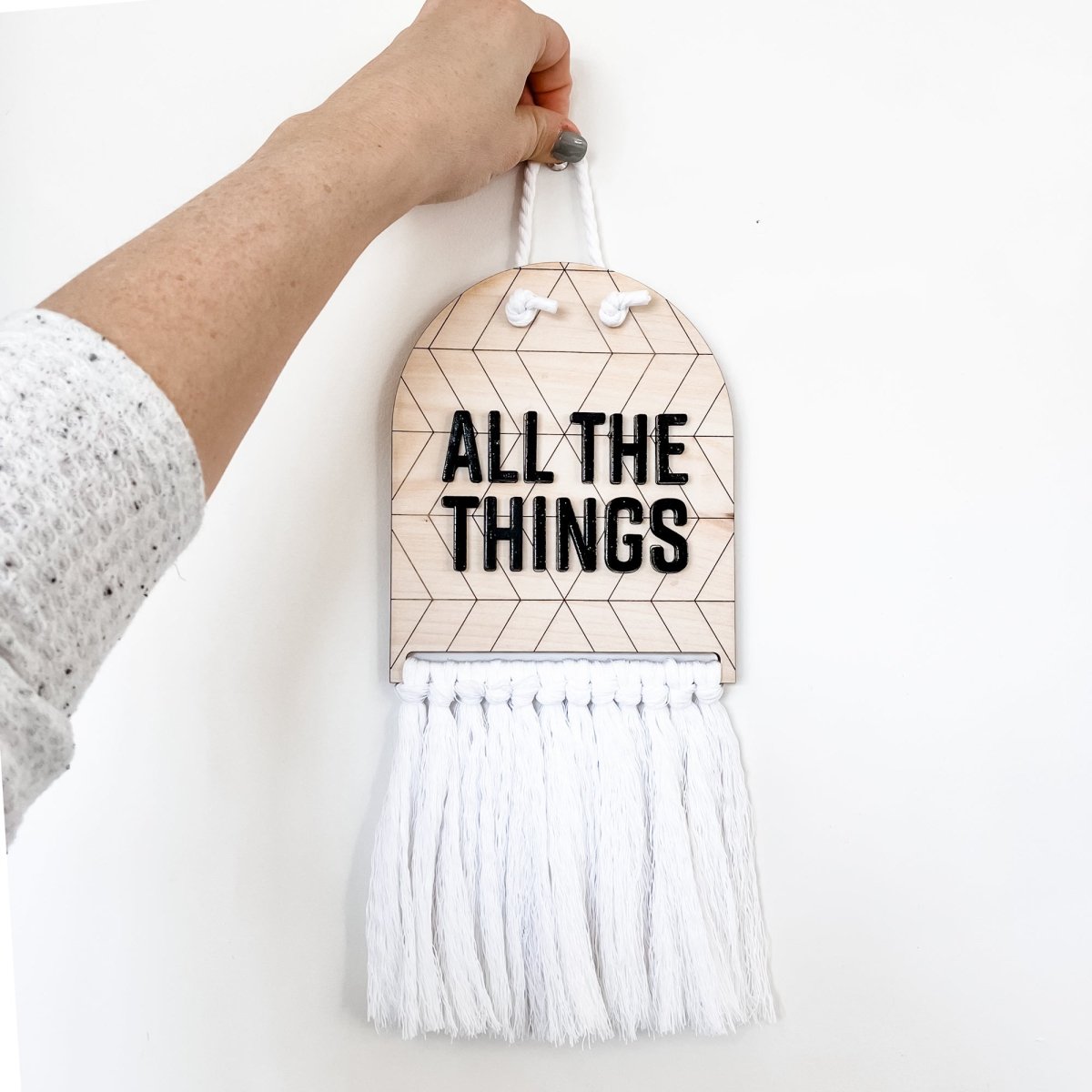 All The Things Half Moon Macrame Sign featuring 3D laser cut lettering on birch maple wood with white rope for hanging.