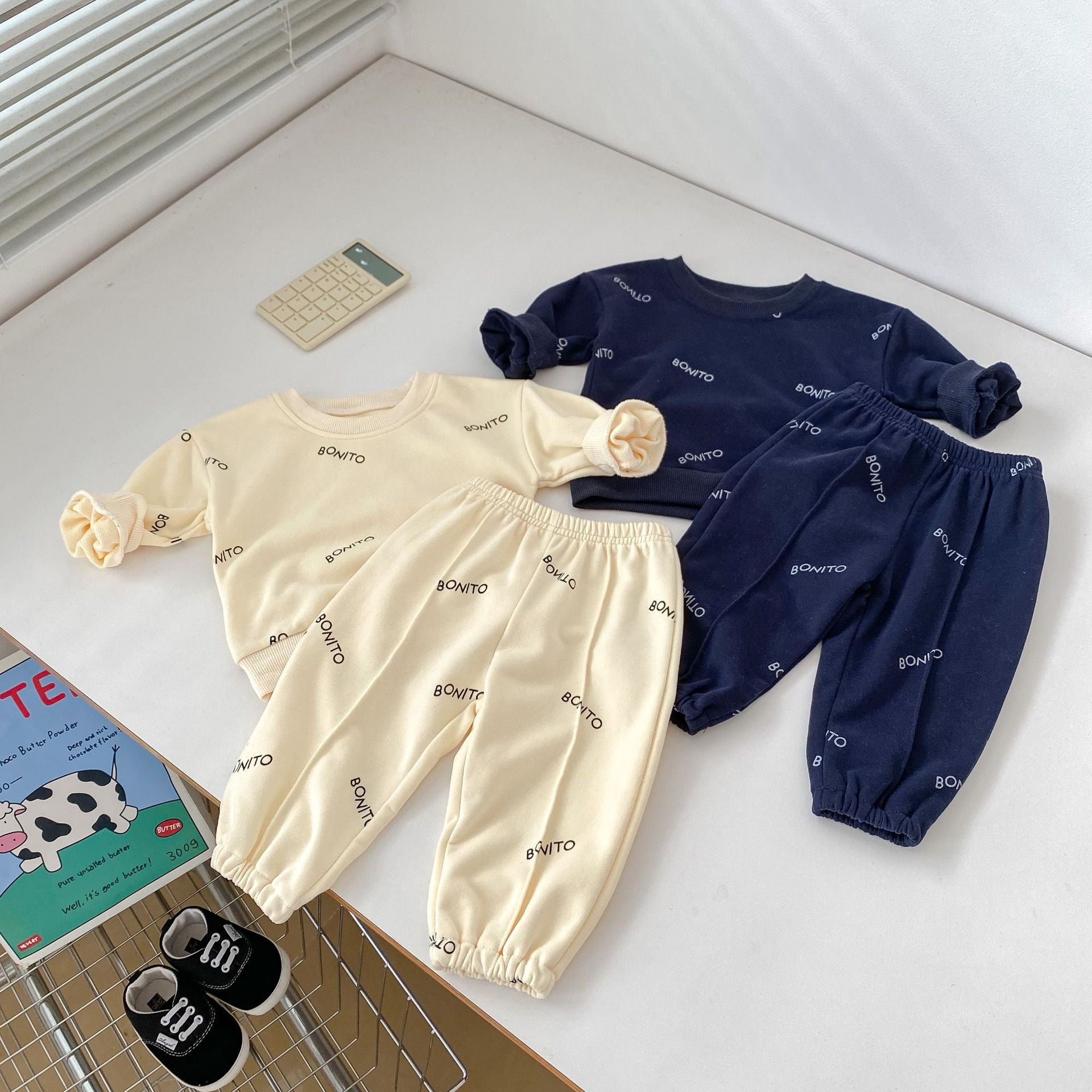 A navy blue and apricot long sleeve shirt for baby boys featuring a simple letters print, made from soft cotton fabric.