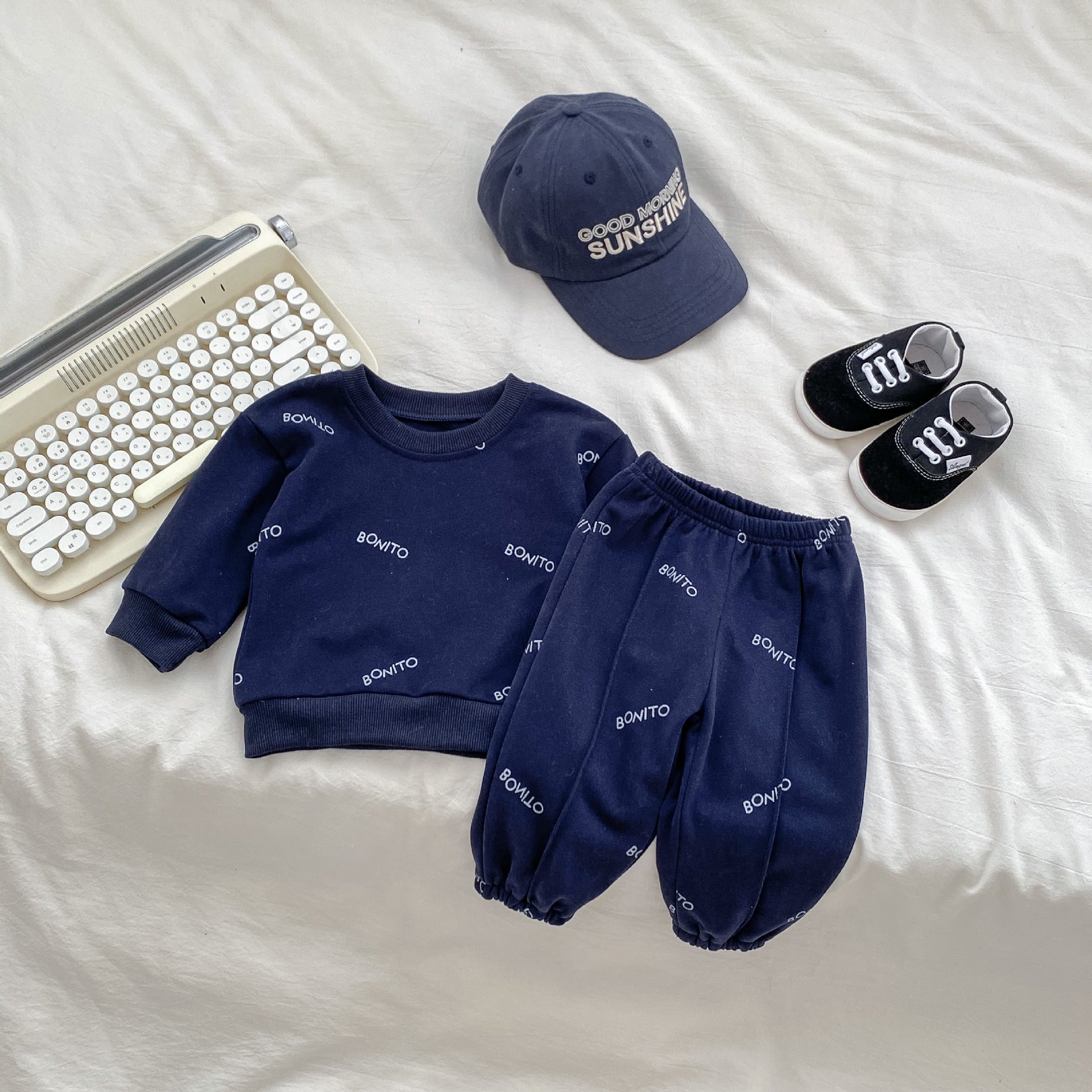 A navy blue and apricot long sleeve shirt for baby boys featuring a simple letters print, made from soft cotton fabric.