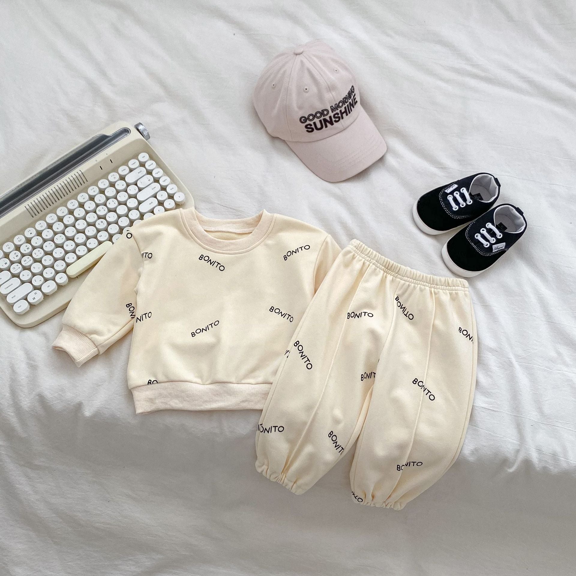 A navy blue and apricot long sleeve shirt for baby boys featuring a simple letters print, made from soft cotton fabric.