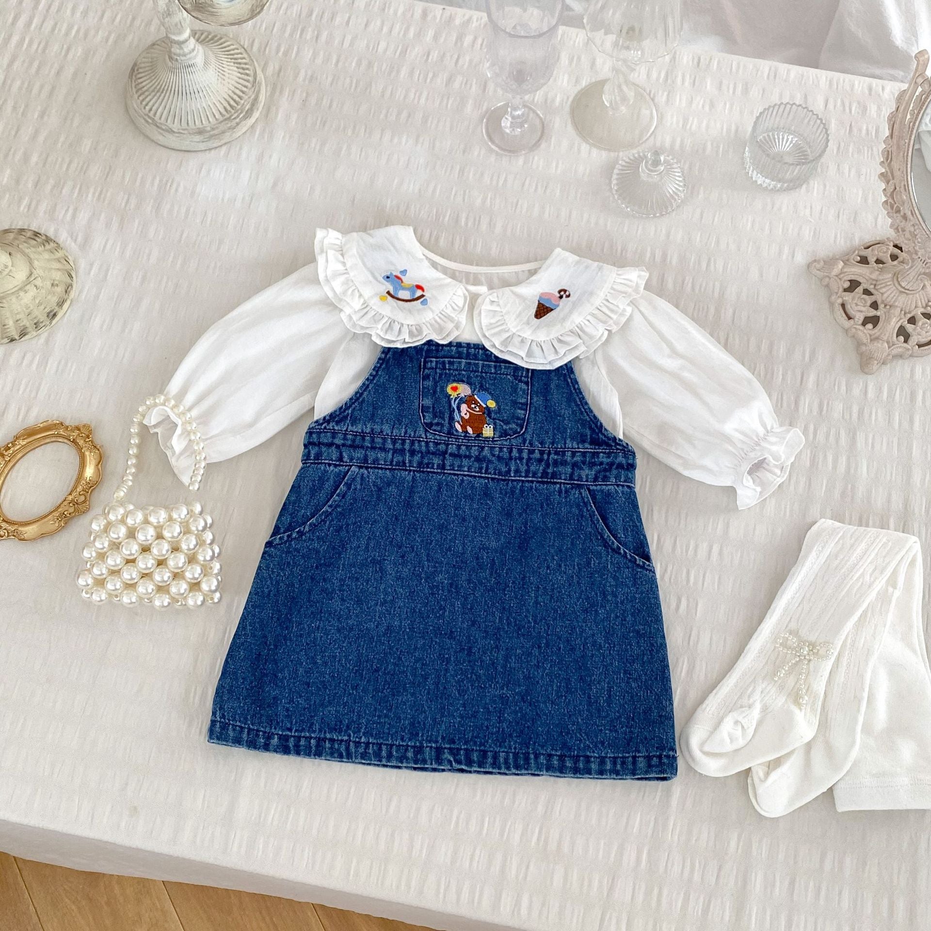 A cute blue and beige long sleeves top for baby girls featuring cartoon embroidery patterns, perfect for autumn and spring wear.