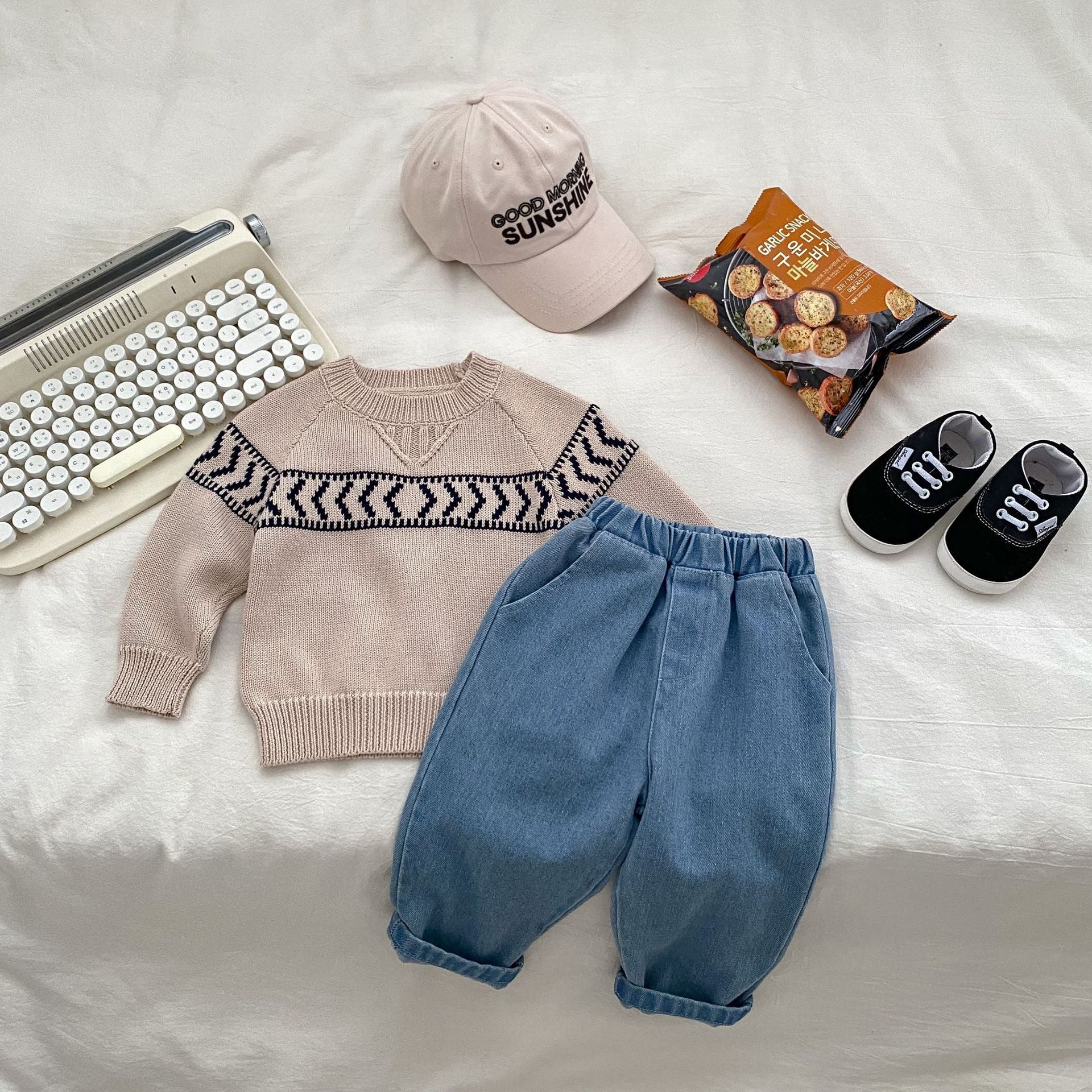 A navy blue and blue knitted pullover for baby boys, featuring long sleeves and geometric patterns, perfect for autumn and winter wear.