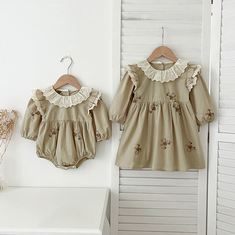 A stylish long-sleeved top for baby girls featuring vintage floral embroidery in green and light green colors, made from soft cotton material.