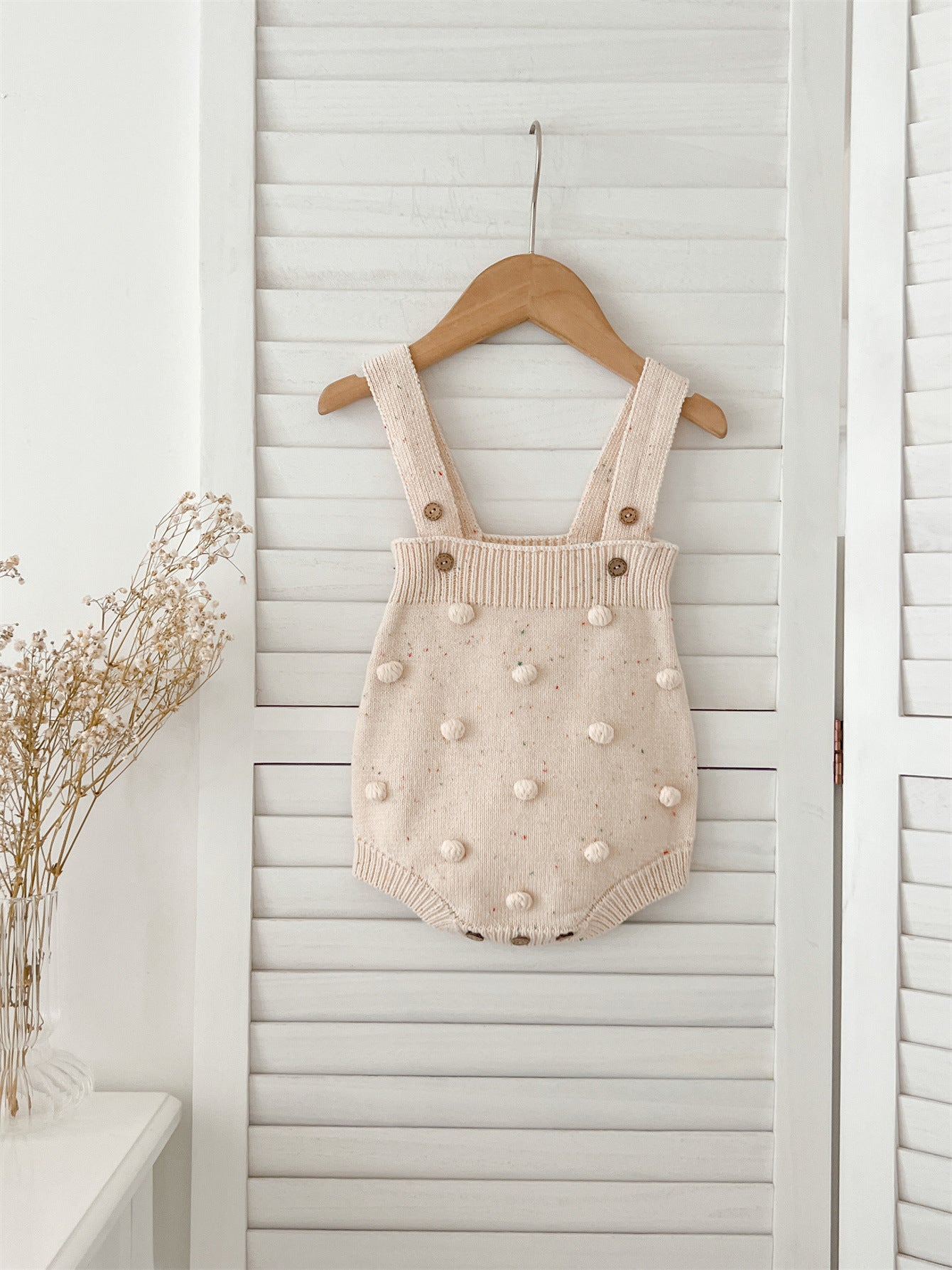 A cozy apricot knitted cardigan for babies with long sleeves, perfect for autumn and spring wear.