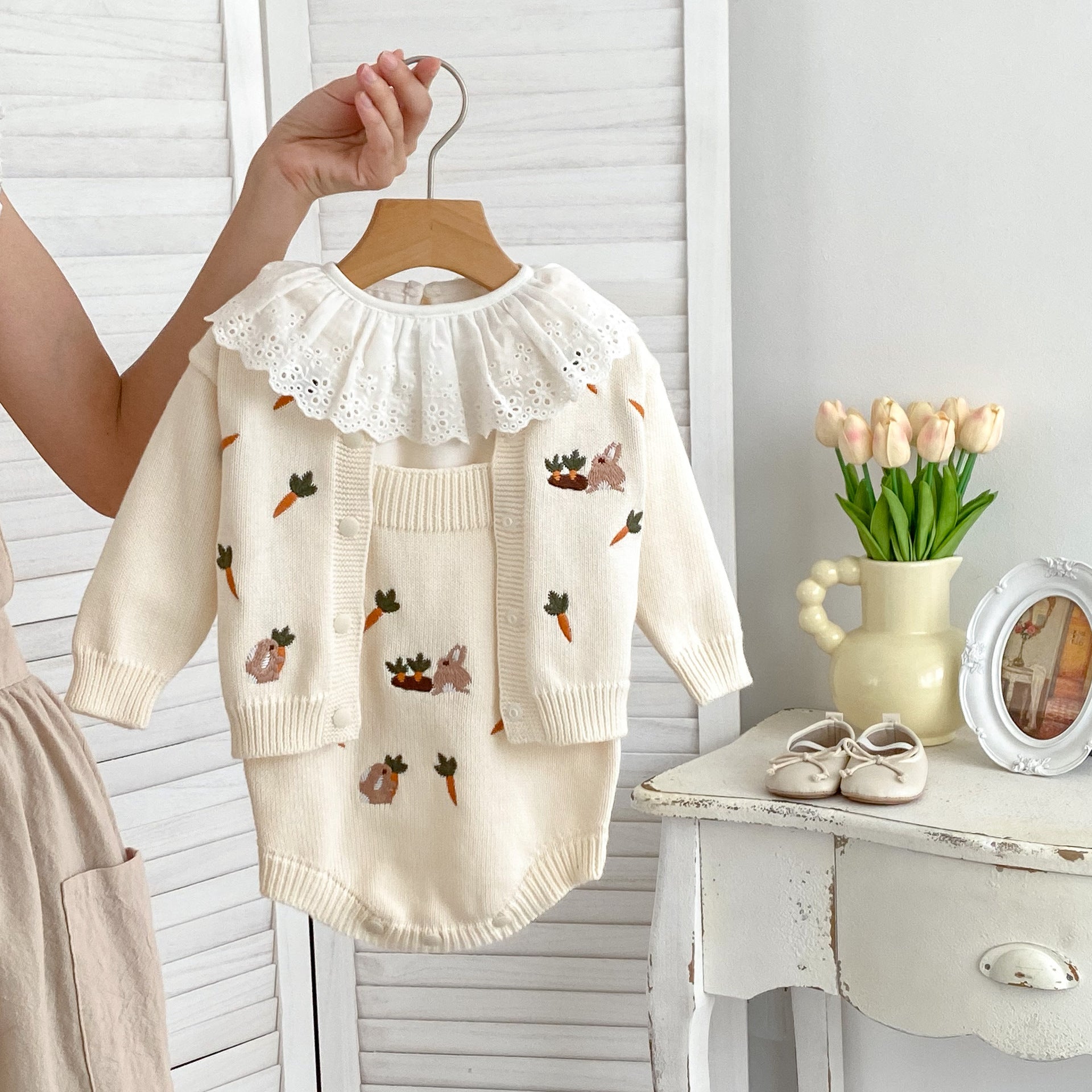 A beige and apricot long-sleeve baby outfit featuring cute cartoon rabbits embroidery, perfect for autumn wear.