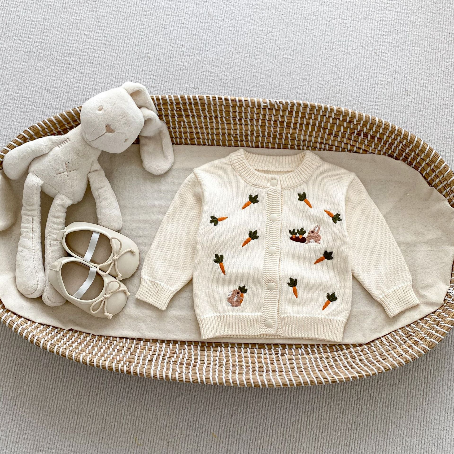 A beige and apricot long-sleeve baby outfit featuring cute cartoon rabbits embroidery, perfect for autumn wear.