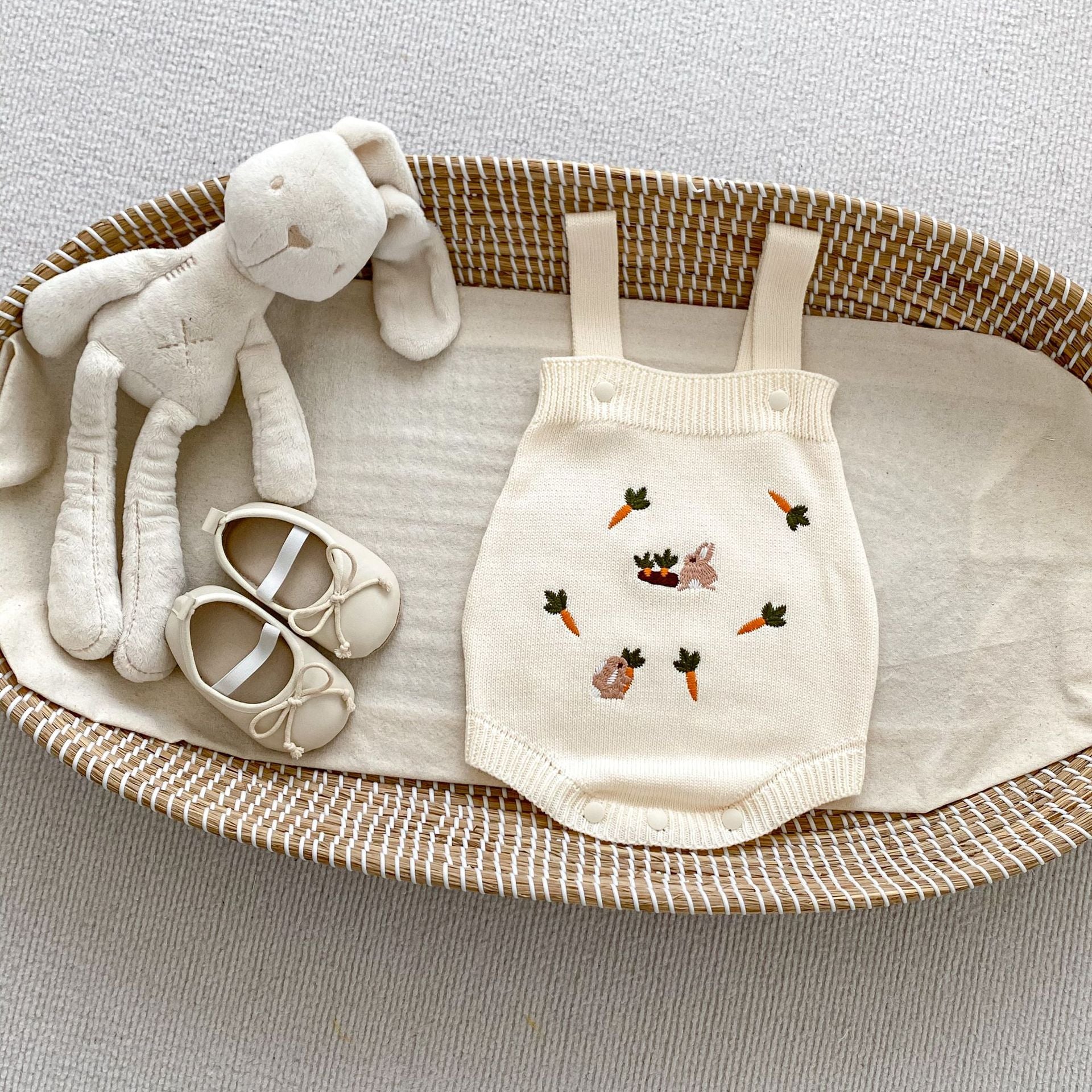 A beige and apricot long-sleeve baby outfit featuring cute cartoon rabbits embroidery, perfect for autumn wear.