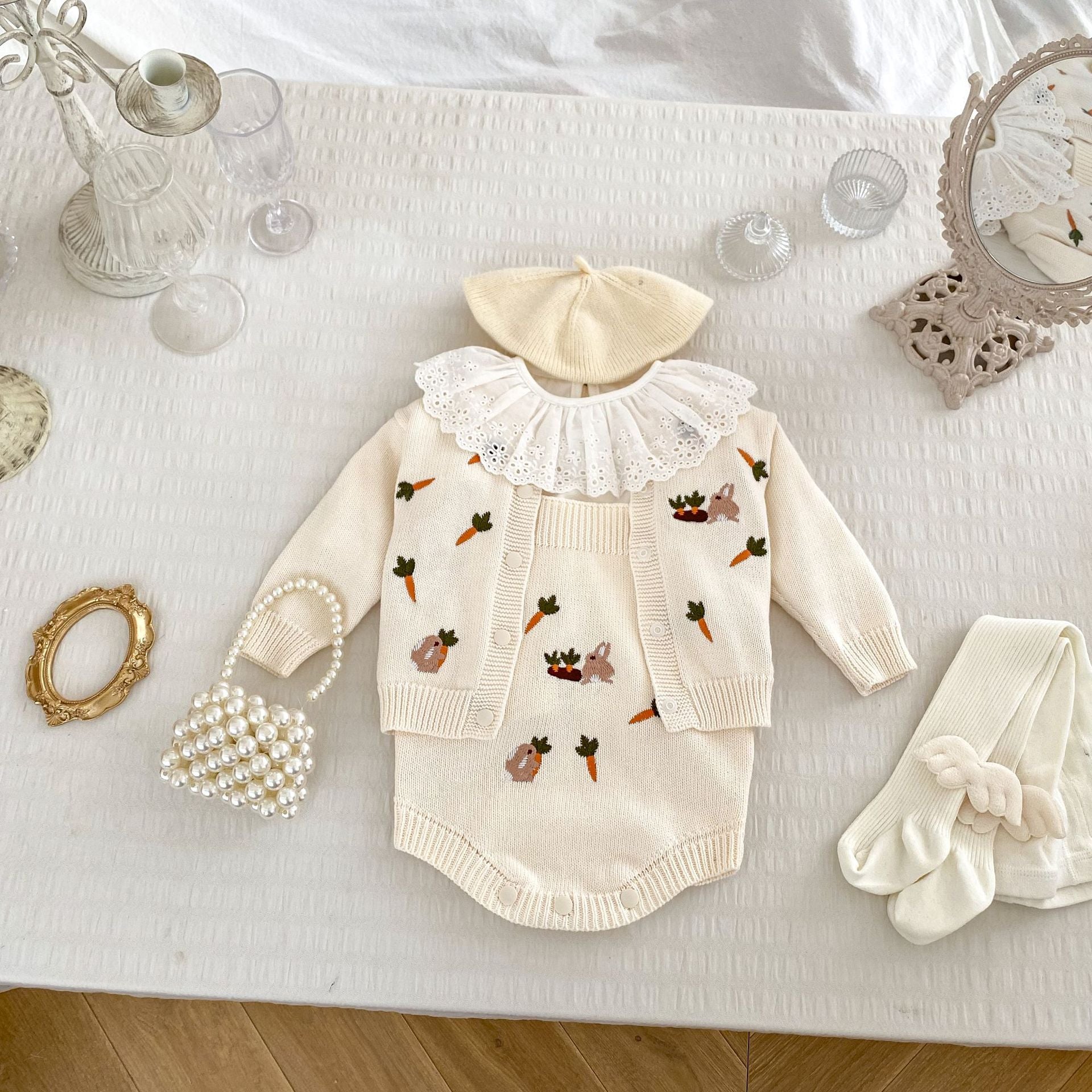 A beige and apricot long-sleeve baby outfit featuring cute cartoon rabbits embroidery, perfect for autumn wear.