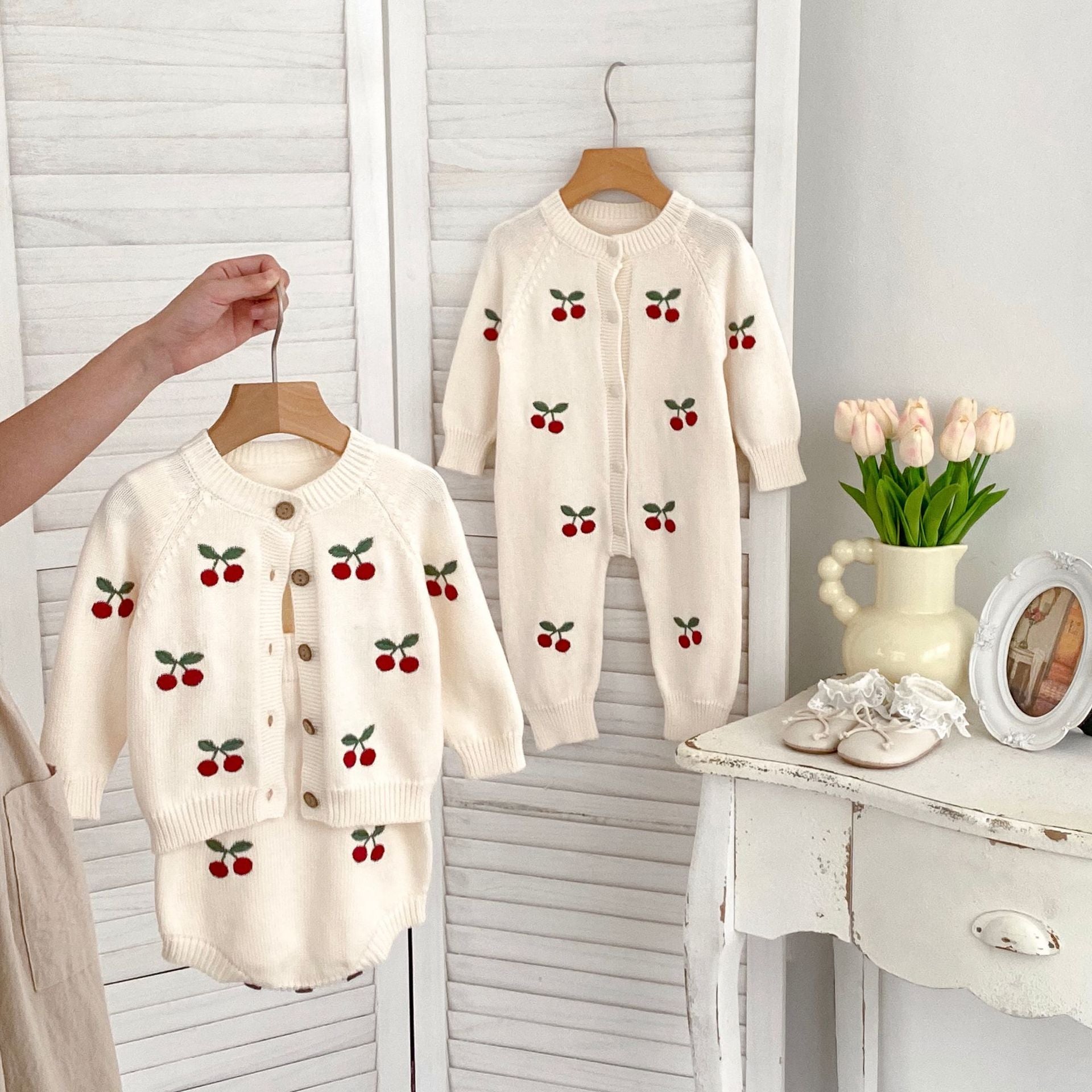 A cozy unisex baby outfit featuring long sleeves and a cherry jacquard pattern, perfect for autumn wear.