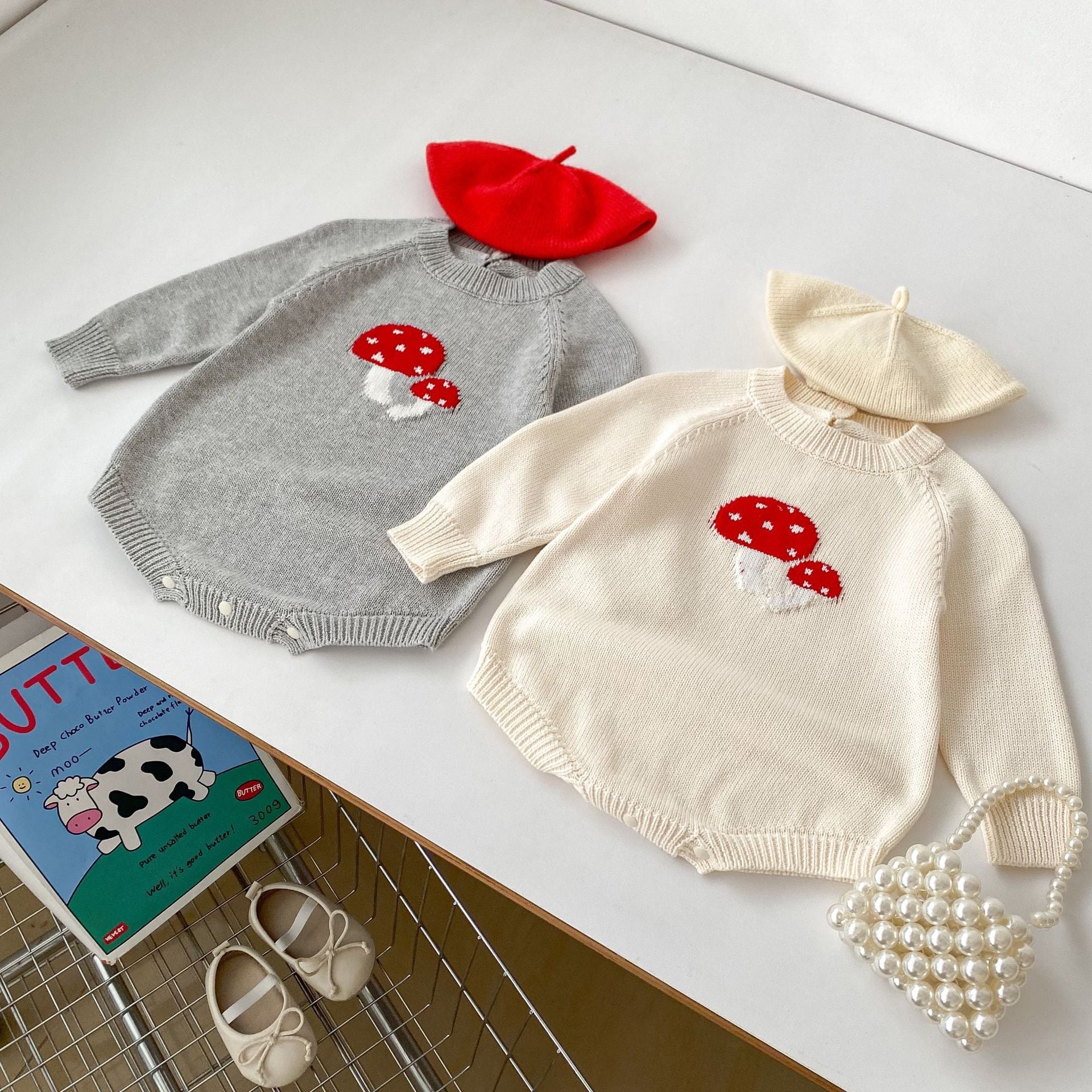 A soft cotton long-sleeved baby top featuring a jacquard mushroom pattern in grey and apricot colors, suitable for both boys and girls.
