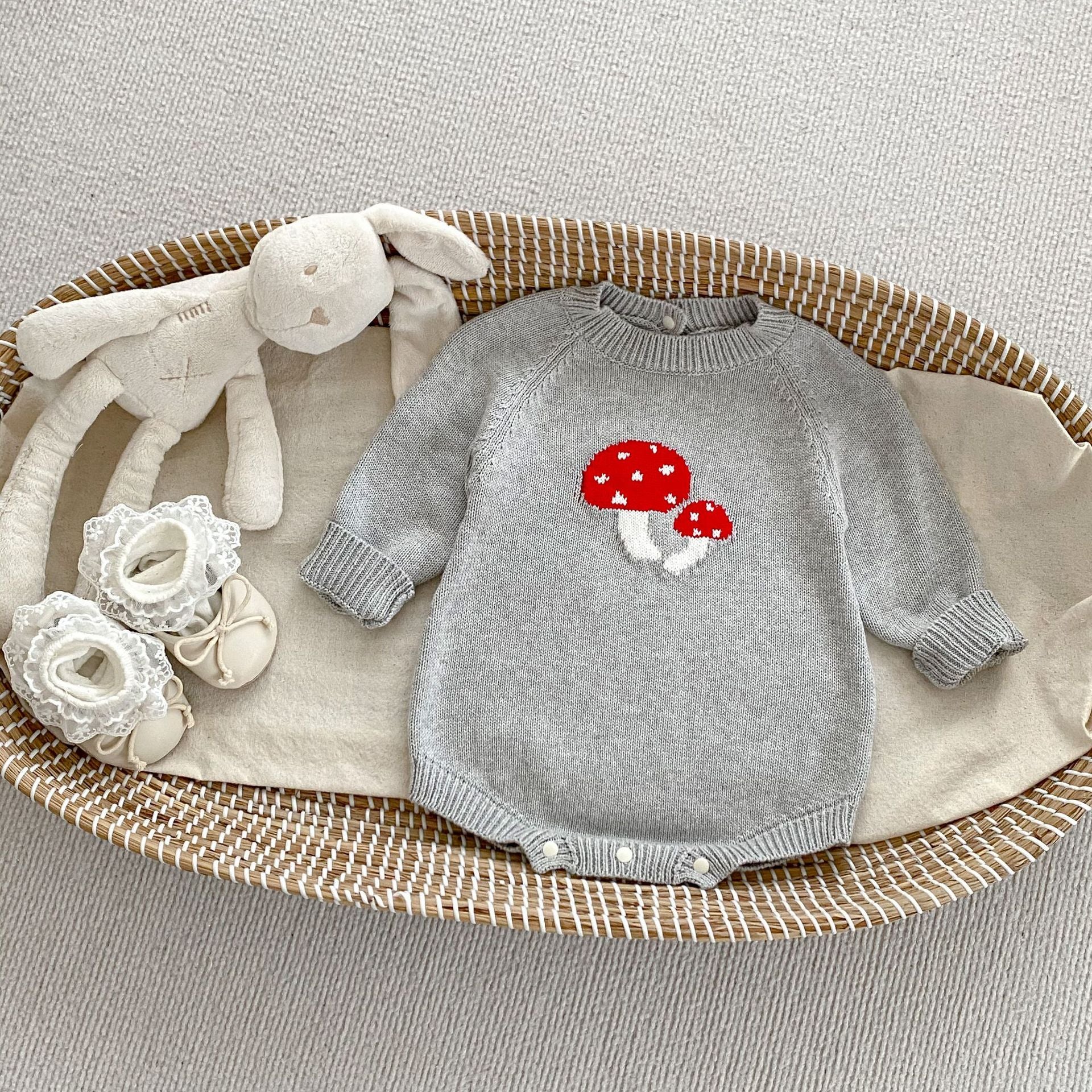 A soft cotton long-sleeved baby top featuring a jacquard mushroom pattern in grey and apricot colors, suitable for both boys and girls.