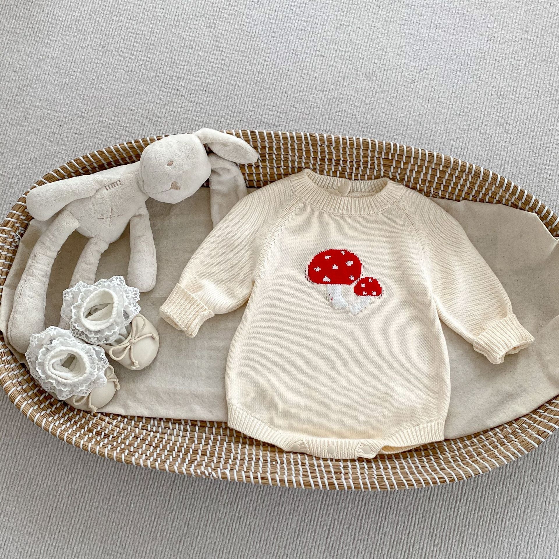 A soft cotton long-sleeved baby top featuring a jacquard mushroom pattern in grey and apricot colors, suitable for both boys and girls.