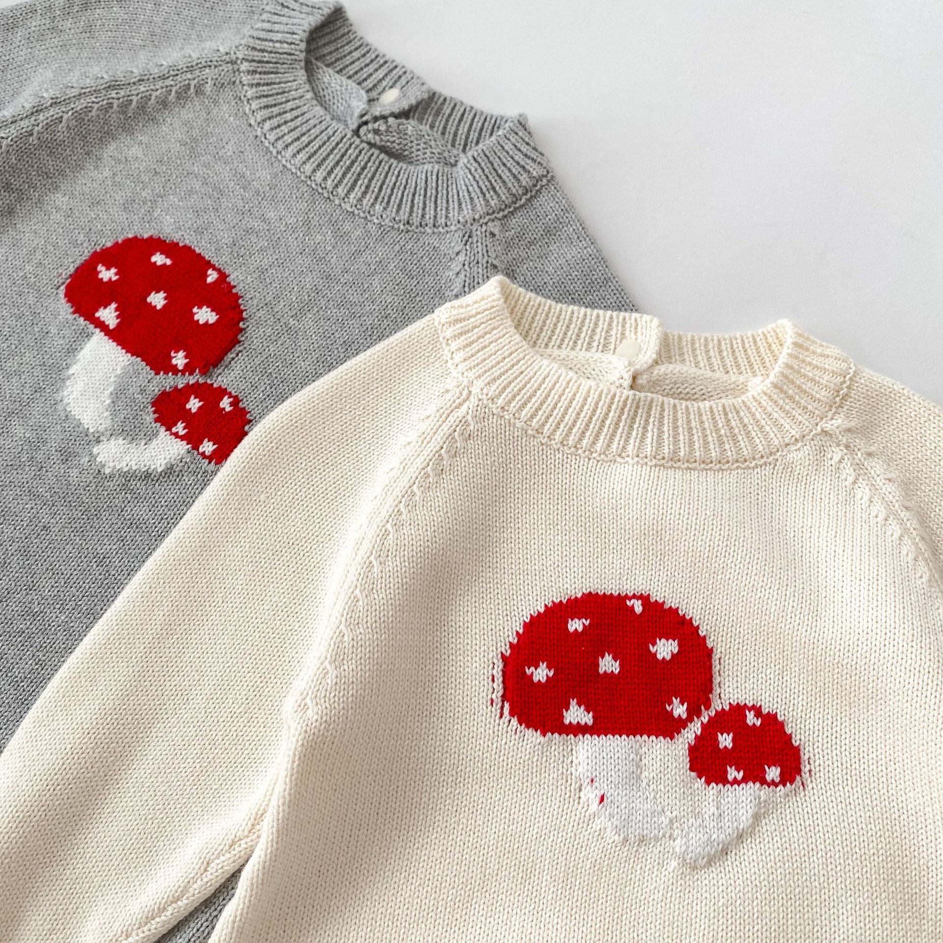 A soft cotton long-sleeved baby top featuring a jacquard mushroom pattern in grey and apricot colors, suitable for both boys and girls.