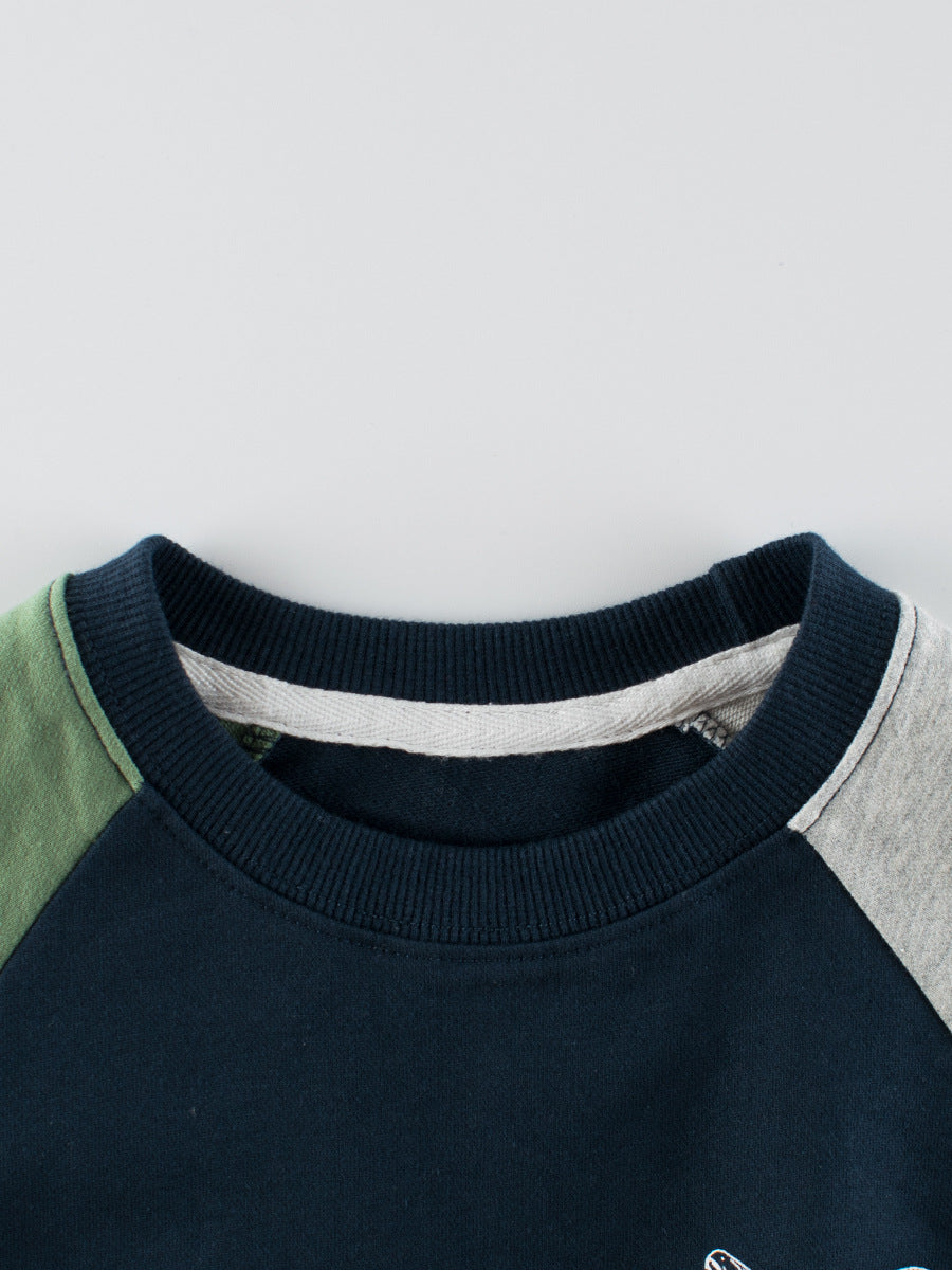 A navy blue and grey long sleeve pullover for boys featuring a playful dinosaur print, made from soft cotton material.
