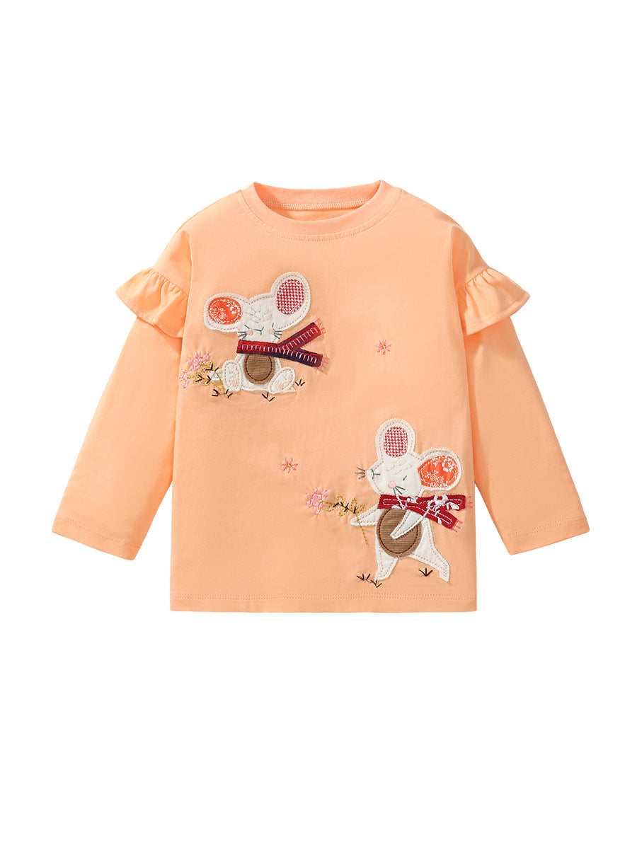 A cute long-sleeve top for girls featuring a cartoon pattern of animals and flowers in apricot color, made from soft cotton material.