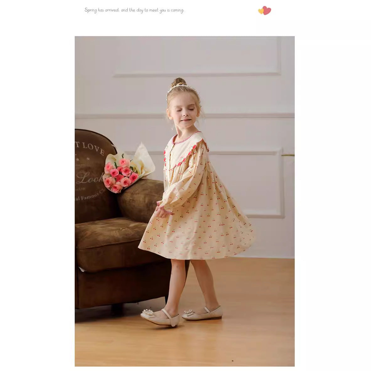 A charming long-sleeved dress for girls featuring a playful cherry pattern, made from soft cotton in apricot color.
