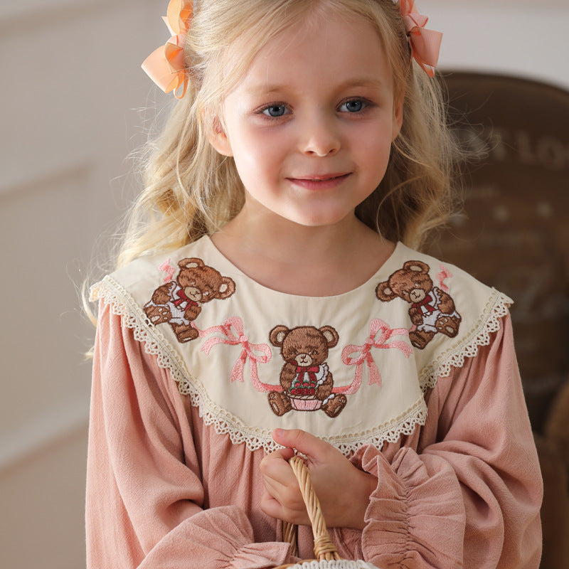 A charming pink long sleeves dress for girls featuring teddy embroidery, perfect for autumn and spring wear.