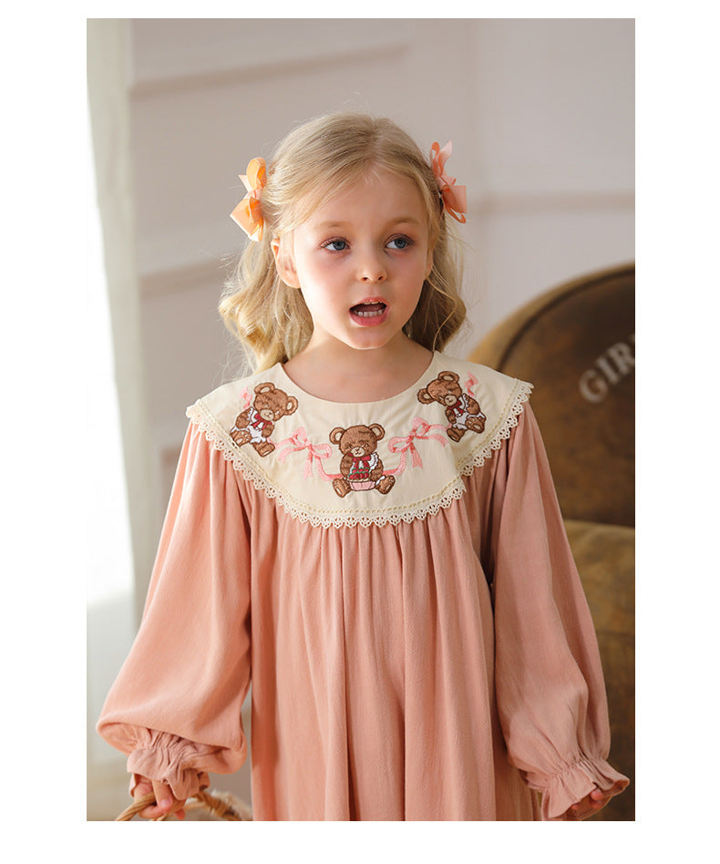 A charming pink long sleeves dress for girls featuring teddy embroidery, perfect for autumn and spring wear.