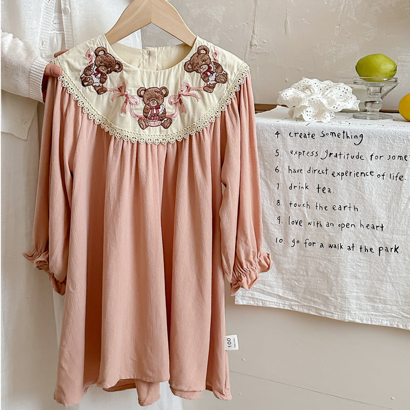 A charming pink long sleeves dress for girls featuring teddy embroidery, perfect for autumn and spring wear.