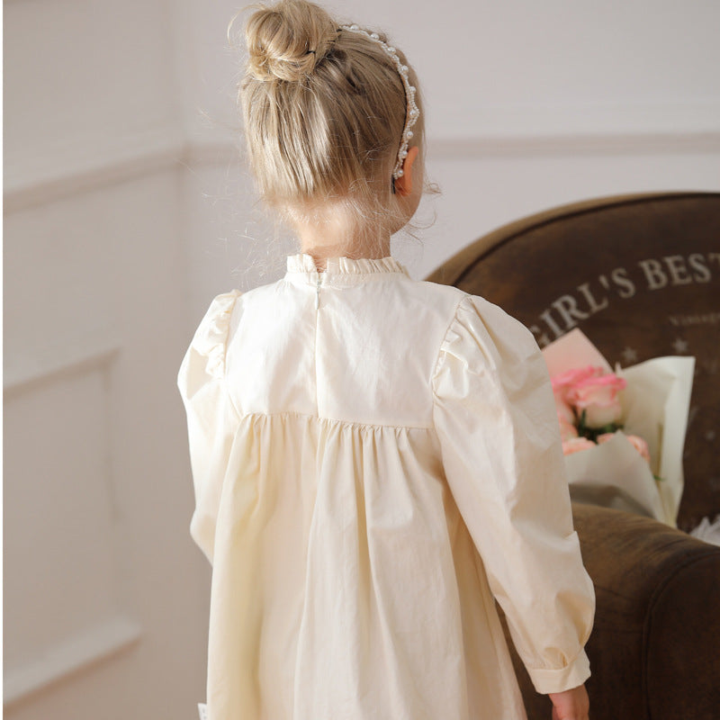 A charming apricot dress for girls featuring ruffle neck and flower embroidery, perfect for autumn and spring wear.