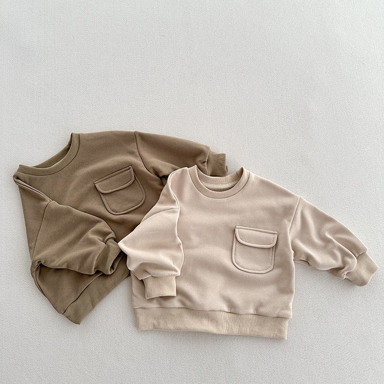 A soft and comfortable unisex long sleeves top for kids in khaki and beige colors, made from cotton fabric.