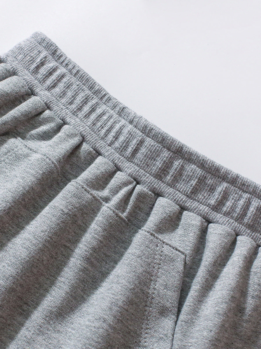 A grey long-sleeve shirt featuring a playful dinosaur print and striped pattern, perfect for boys aged 12 months to 10 years.