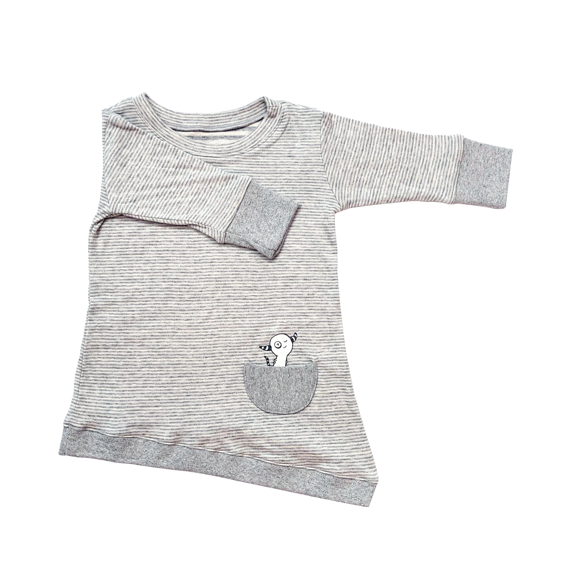 Asymmetric dress for toddlers featuring grey skinny stripes, thumbholes, and a peek-a-boo front pocket.
