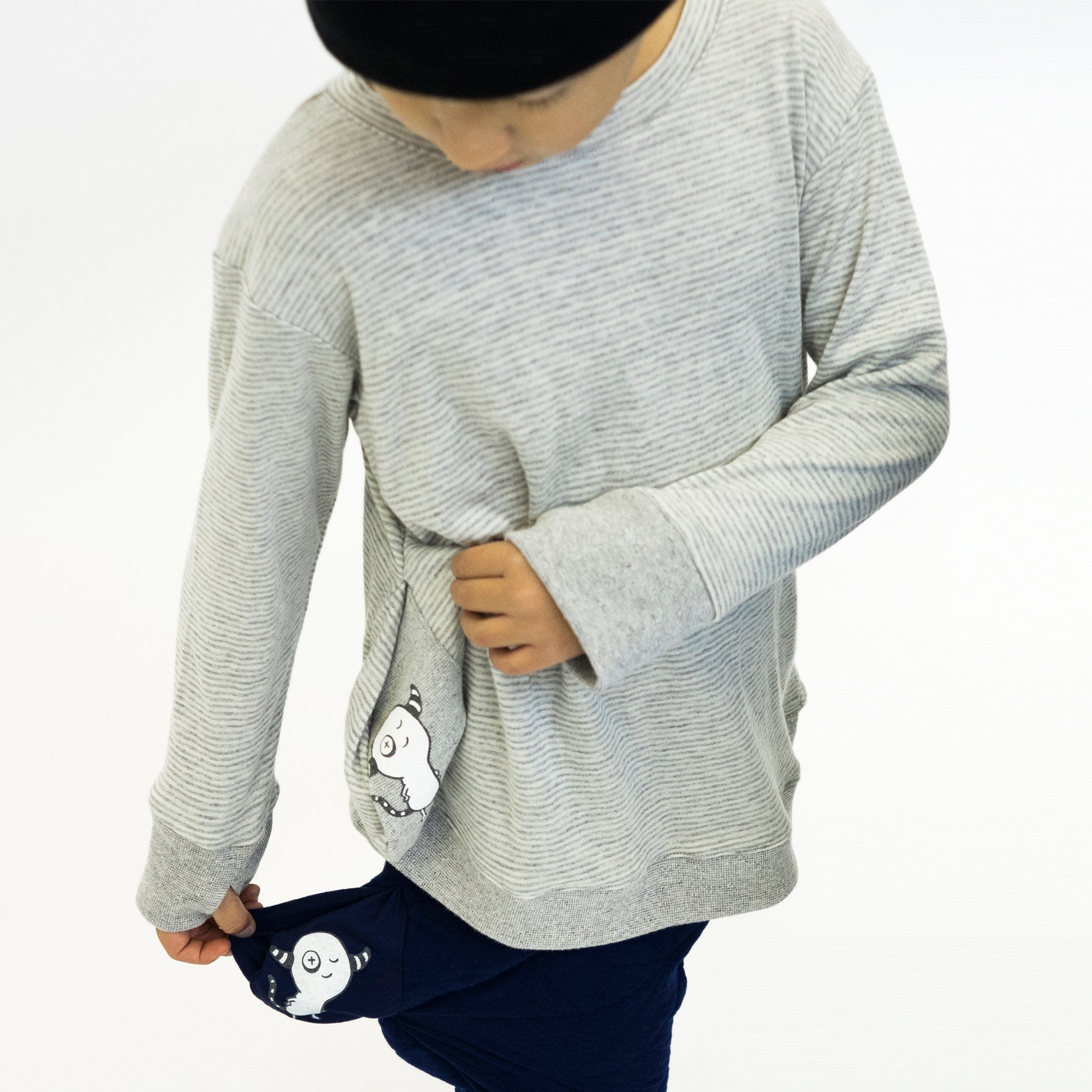 Youth Asymmetric Pullover in Grey with Skinny Stripes, featuring a hidden pocket and thumbholes for added comfort.