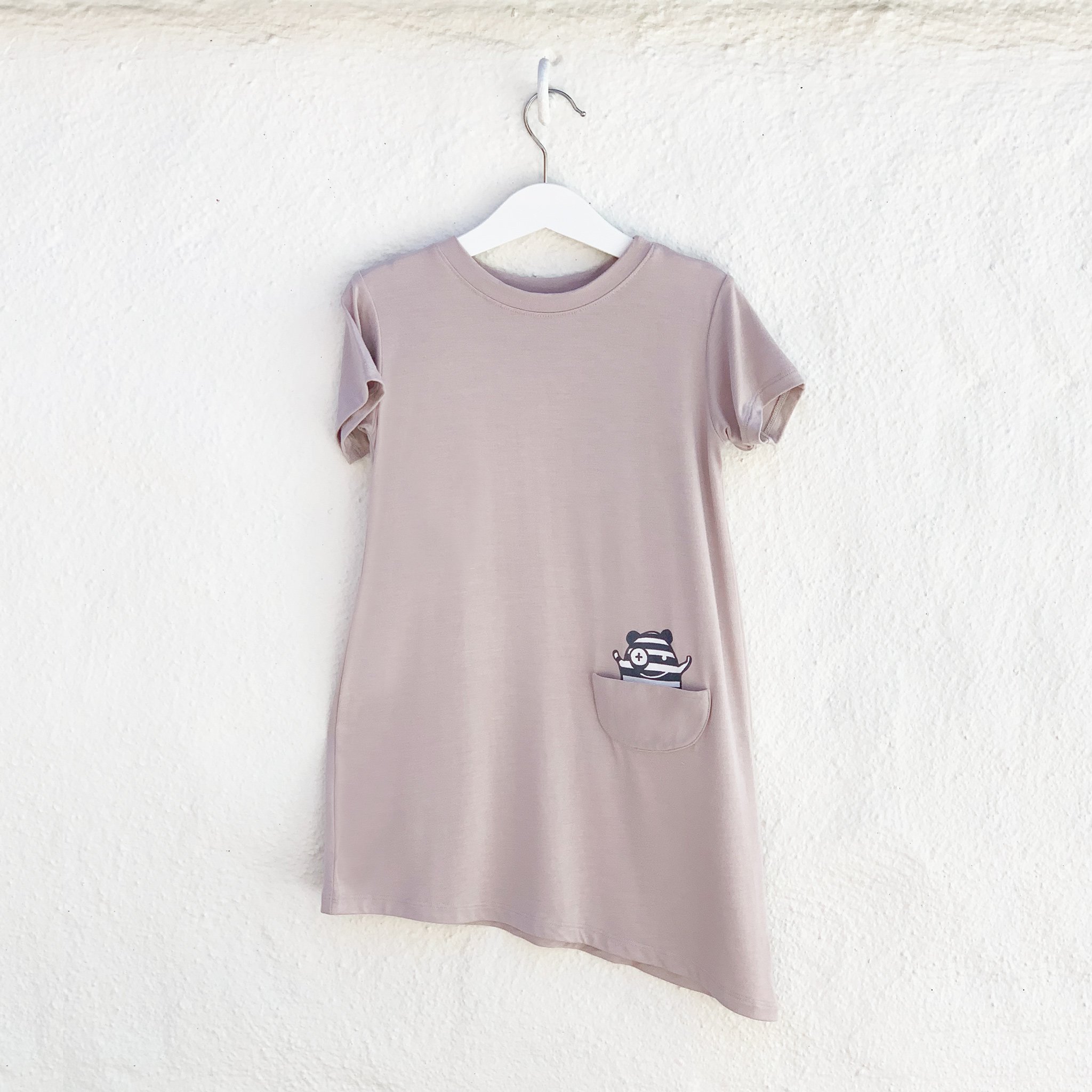Asymmetric T-shirt Dress in Mocha featuring a monster peek-a-boo pocket and unique hem design, perfect for young girls.