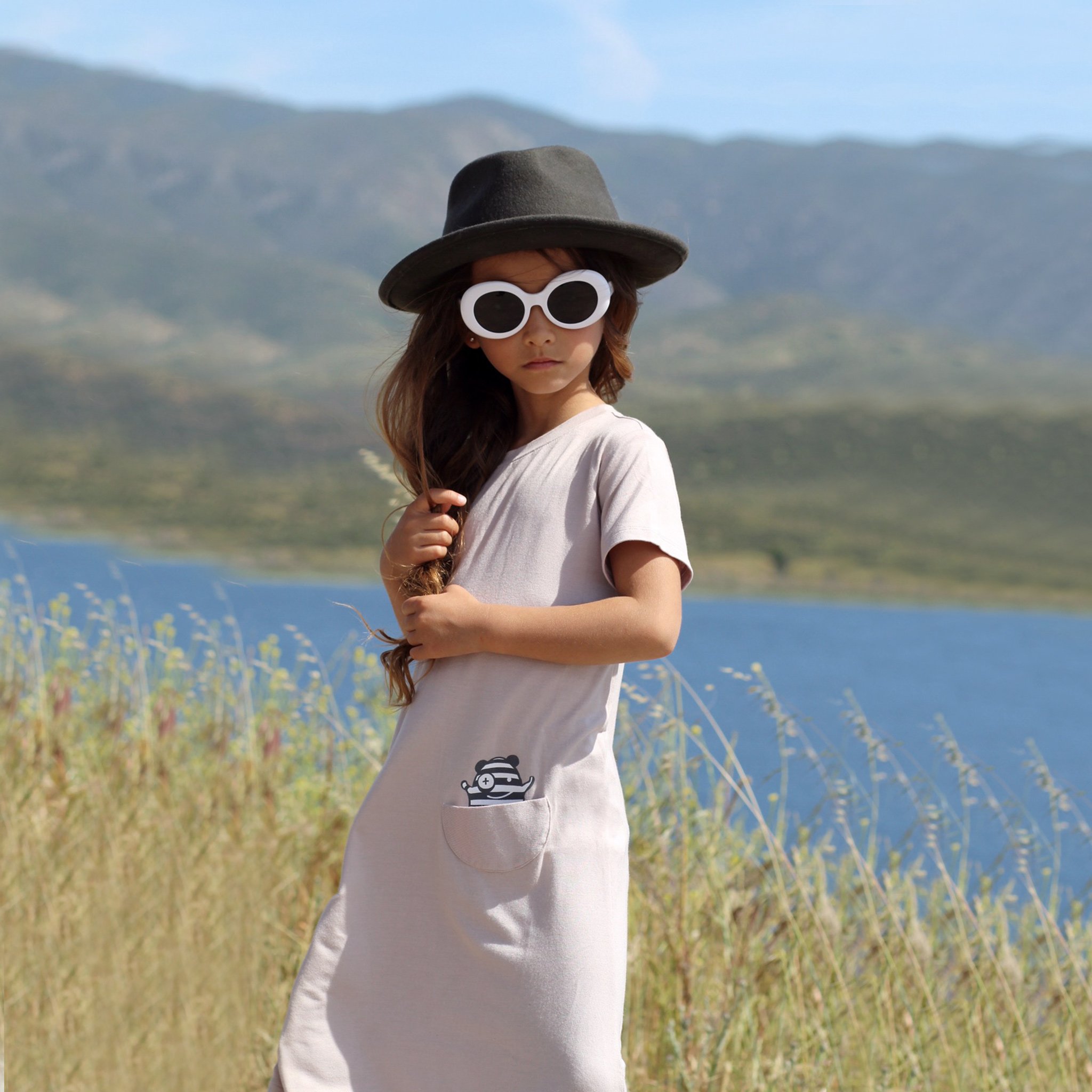 Asymmetric T-shirt Dress in Mocha featuring a monster peek-a-boo pocket and unique hem design, perfect for young girls.