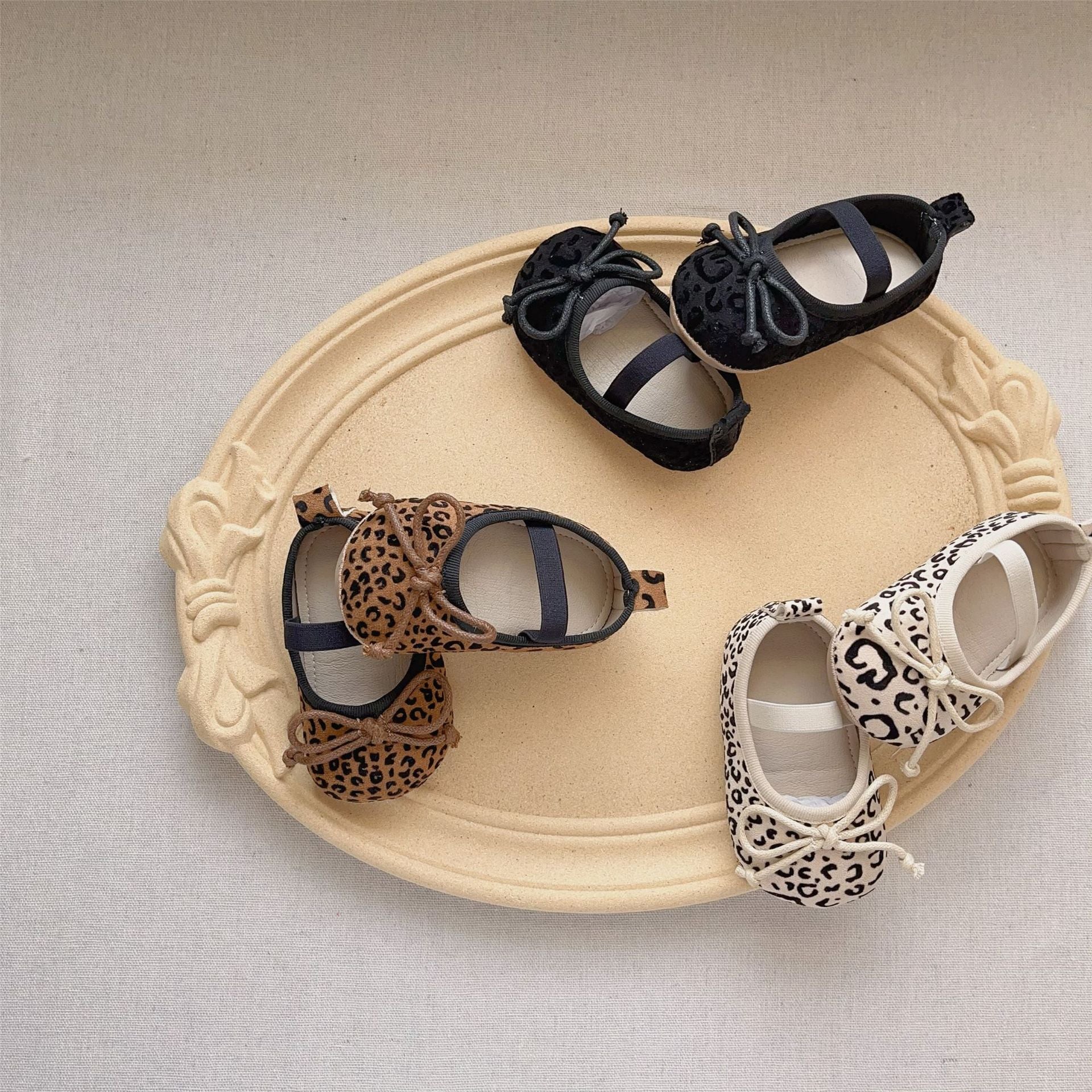 Autumn Baby Girl Leopard Pattern Toddler Soft-Sole Anti-slip Walking Shoes in black, beige, and brown colors, showcasing their stylish design and soft sole.