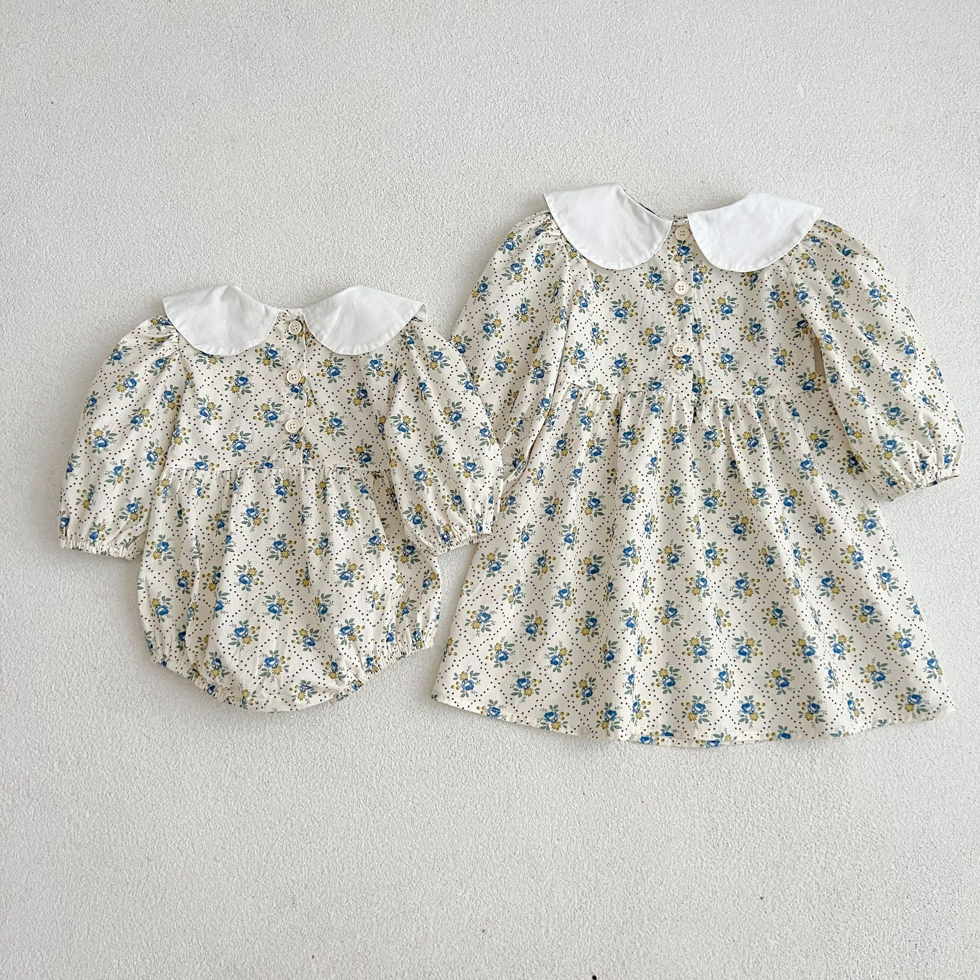 A cute Autumn Ditsy Flower Pattern Doll Neck Onesies Dress in vibrant colors, featuring a floral design suitable for baby girls and young girls.