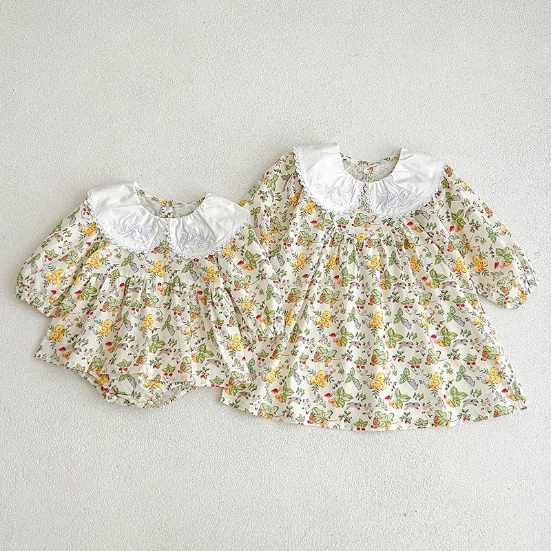 A cute Autumn Doll Neck Long Sleeve Dress Onesie for baby girls in white and yellow colors, featuring a floral pattern.