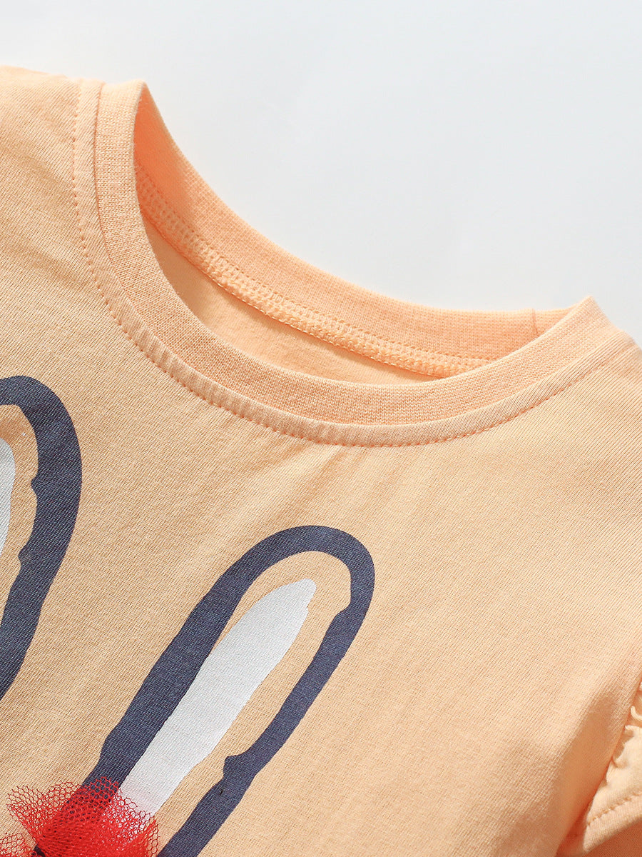 A cute long-sleeved t-shirt for girls featuring a rabbit cartoon pattern, made from soft cotton in apricot color.