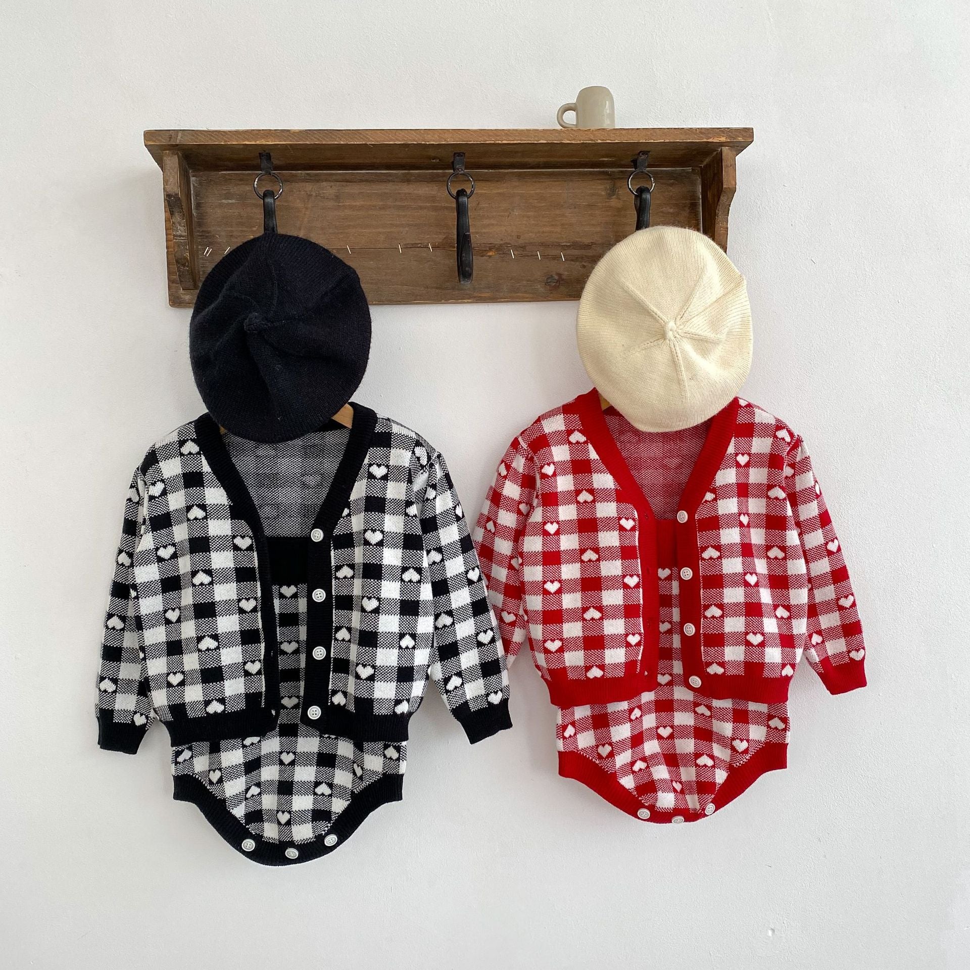 A cozy Autumn Heart Pattern Knitted Onesie and Cardigan Set for baby girls in black and red colors, featuring a cute heart design.