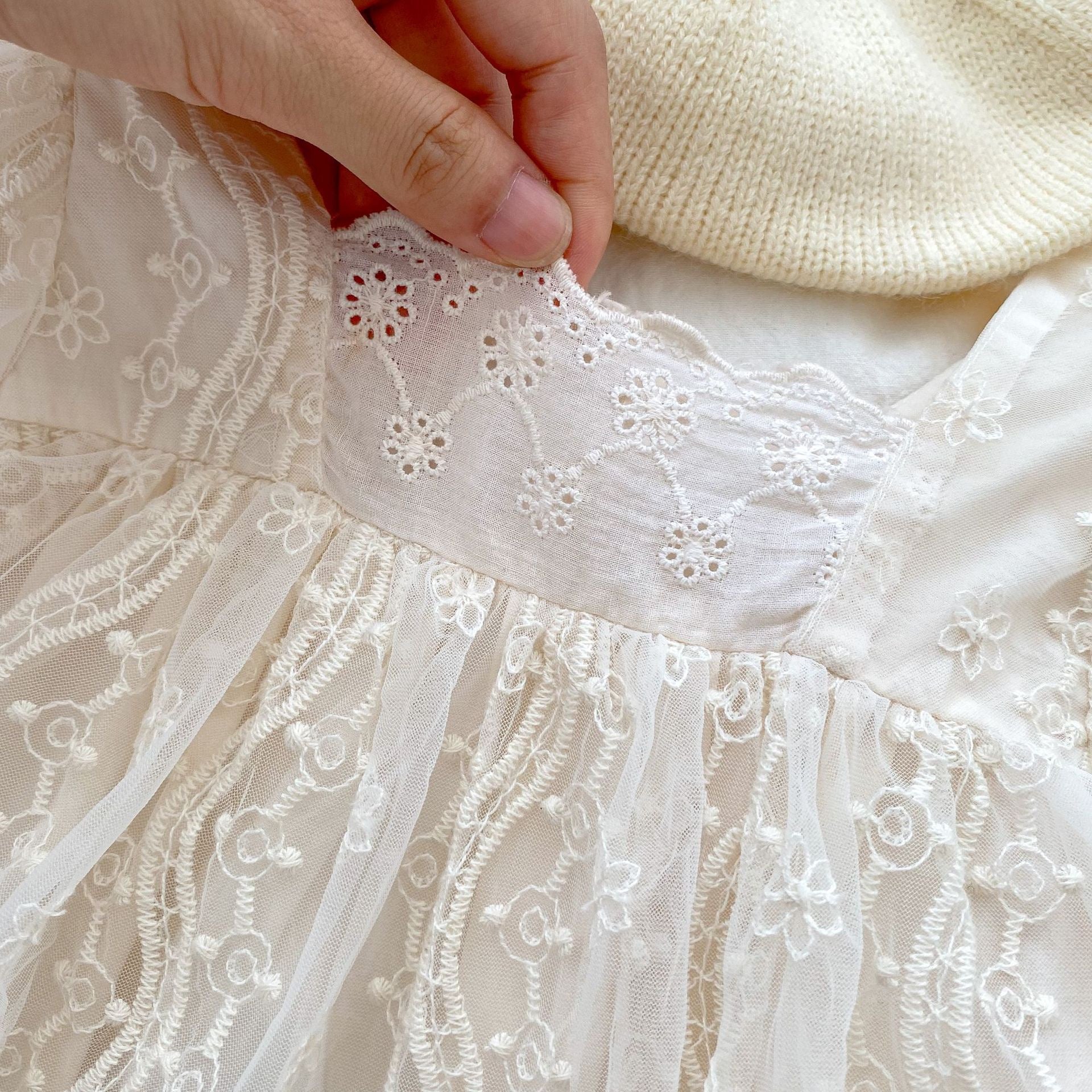 A stylish apricot onesies dress for baby girls featuring a mesh patched design, perfect for autumn wear.