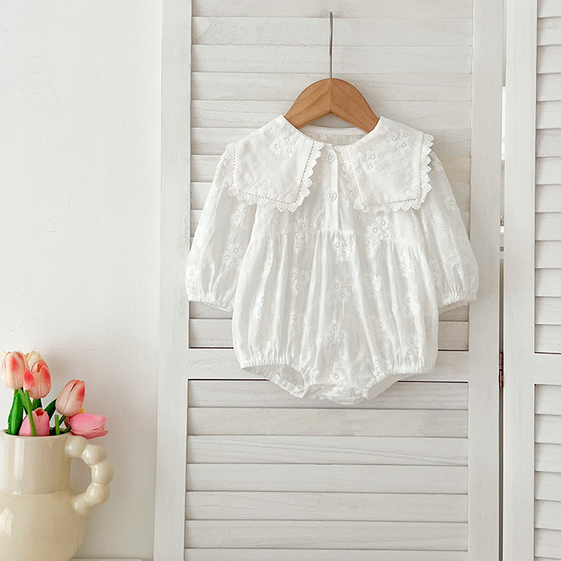 Baby girl wearing a long-sleeve floral patterned outfit in white, showcasing a stylish and comfortable design for autumn.