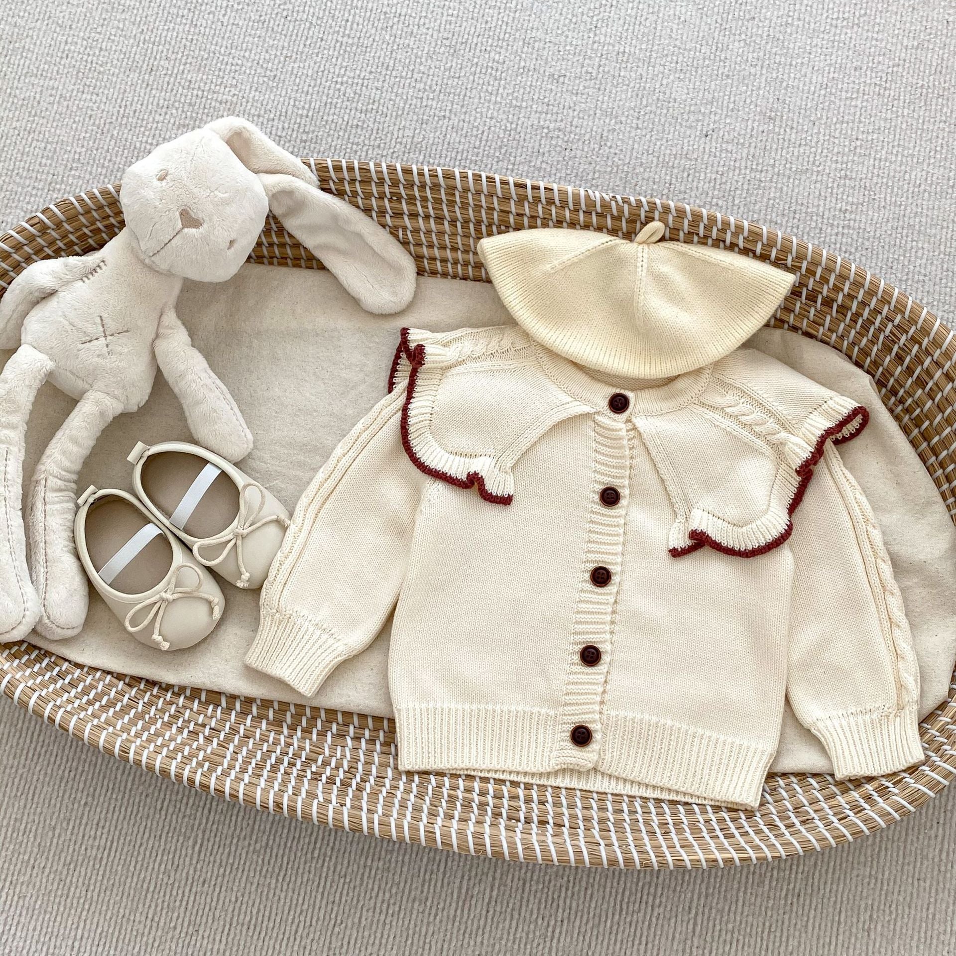A cozy Autumn Vintage Style Knitted Cardigan for Baby Girl in red and beige, featuring floral and plain patterns, perfect for chilly weather.