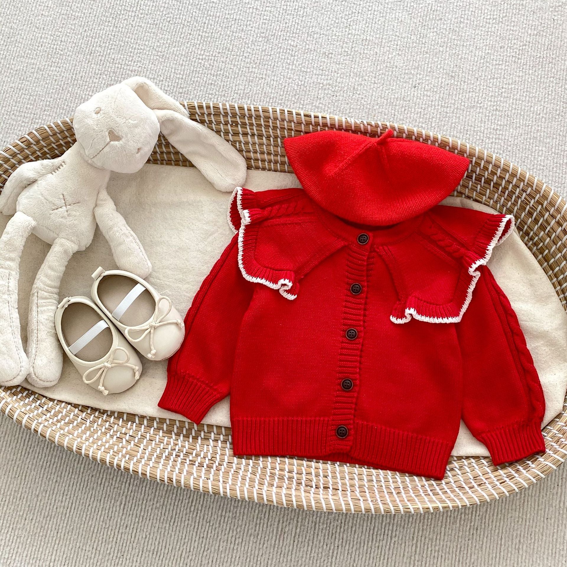 A cozy Autumn Vintage Style Knitted Cardigan for Baby Girl in red and beige, featuring floral and plain patterns, perfect for chilly weather.