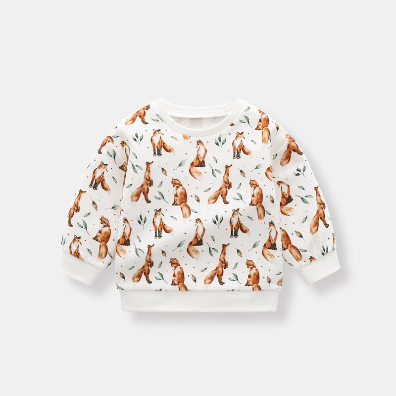 Baby wearing a brown organic cotton hoodie with an all-over fox graphic, showcasing comfort and style.