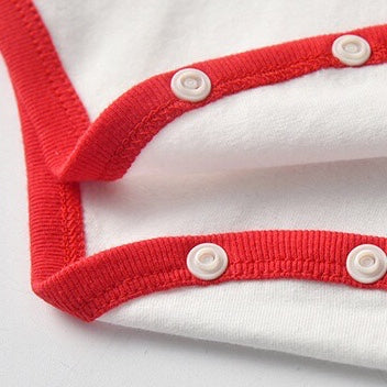 A stylish Baby Bow Tie Patched Onesie Bodysuit in vibrant colors, featuring a bow tie and patchwork design, perfect for special occasions.