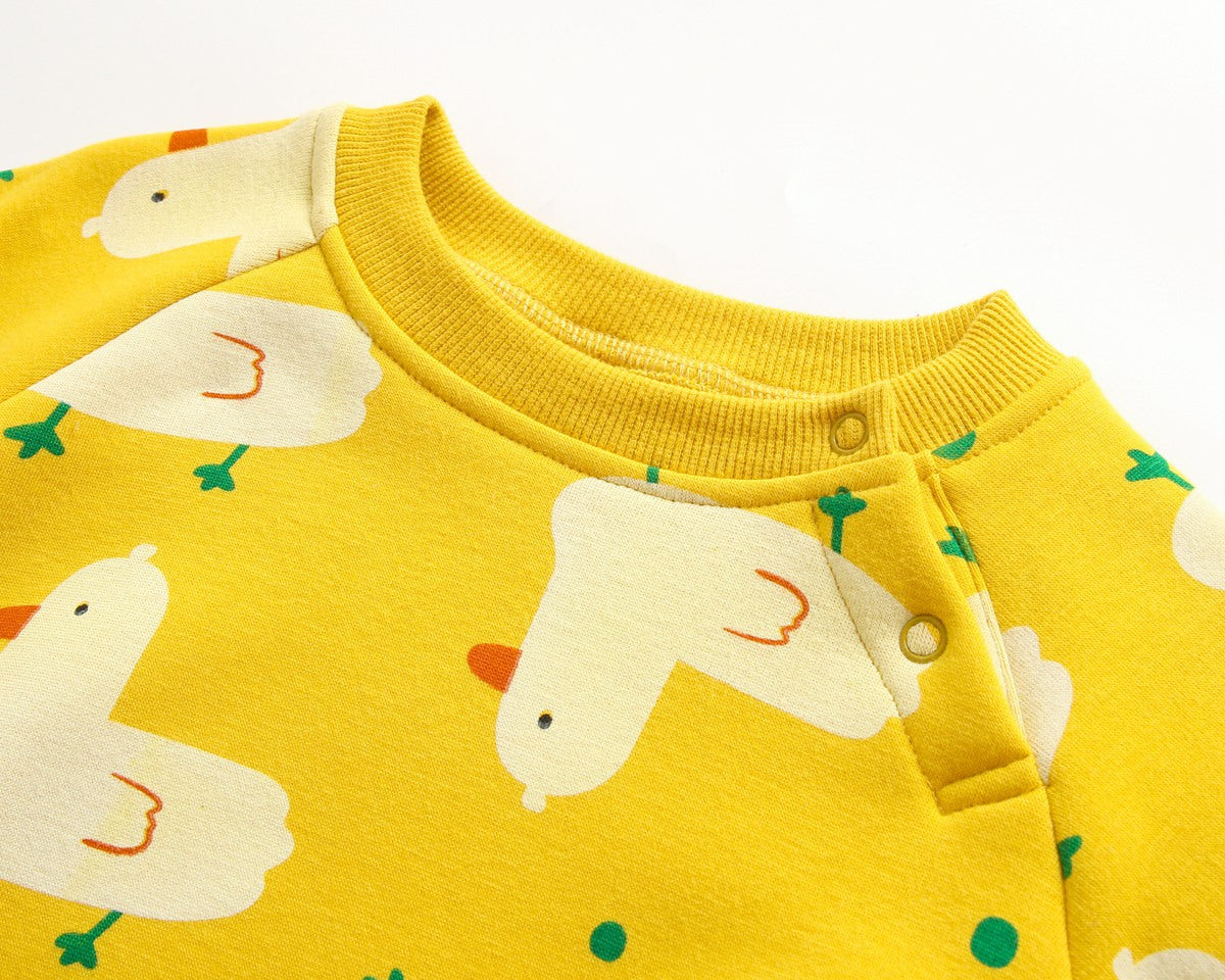 Baby wearing a cute cartoon duck print romper with matching hat, showcasing vibrant colors and playful design.