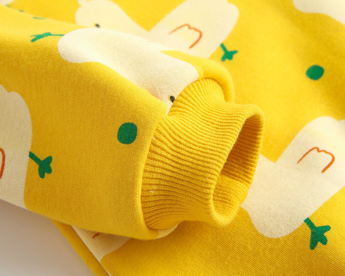 Baby wearing a cute cartoon duck print romper with matching hat, showcasing vibrant colors and playful design.