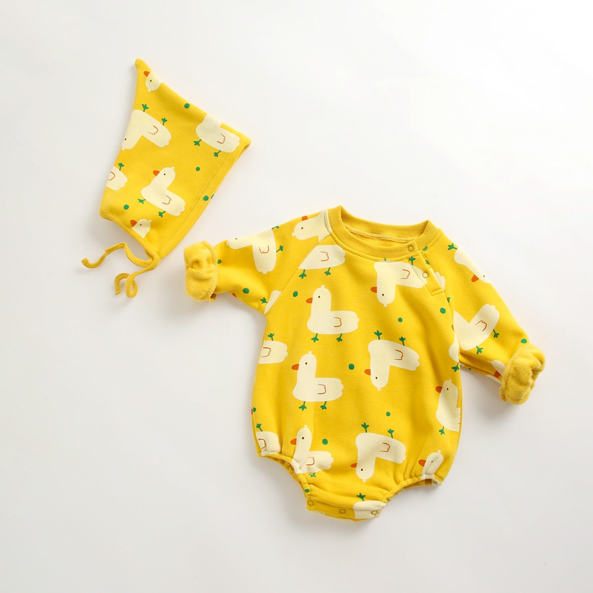 Baby wearing a cute cartoon duck print romper with matching hat, showcasing vibrant colors and playful design.