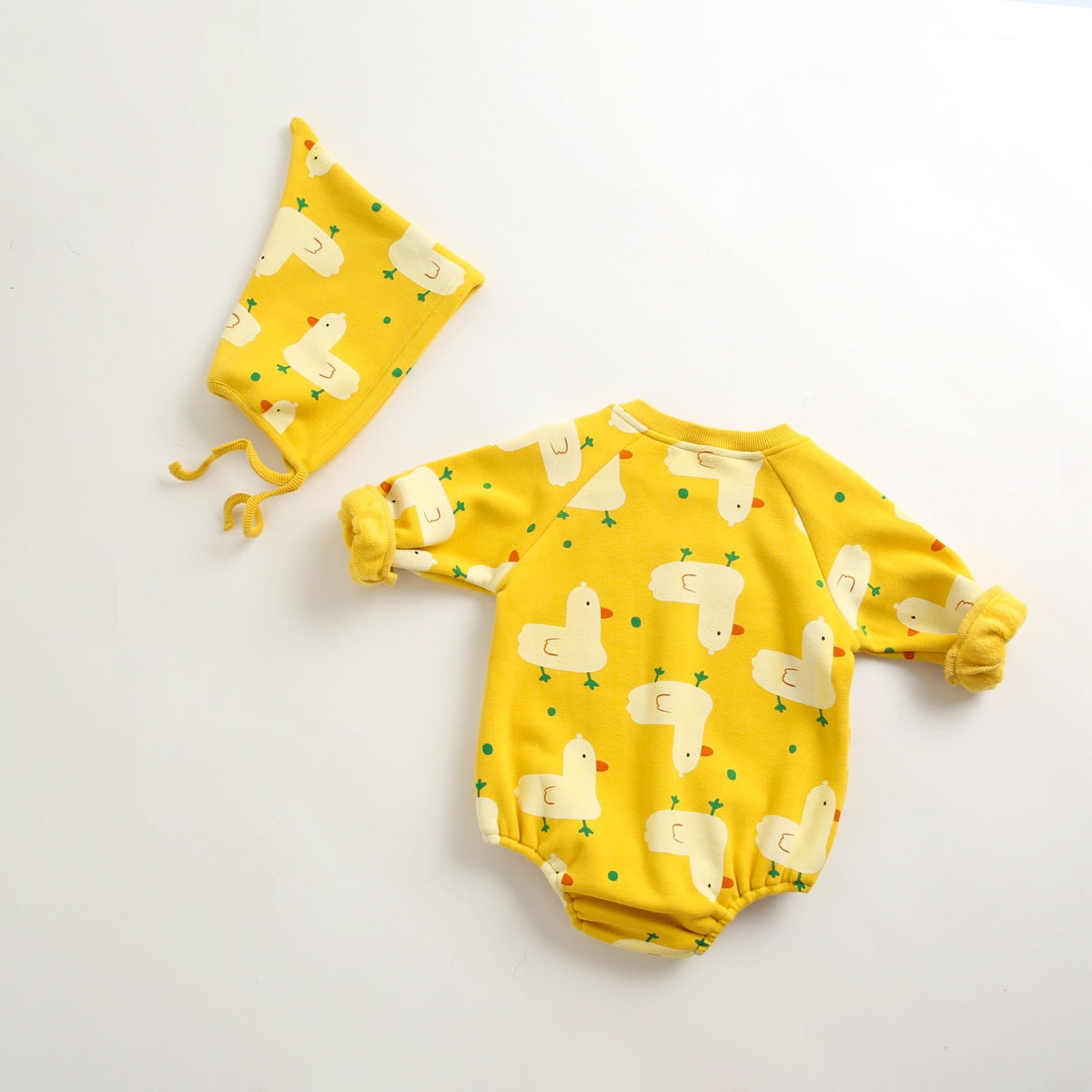 Baby wearing a cute cartoon duck print romper with matching hat, showcasing vibrant colors and playful design.