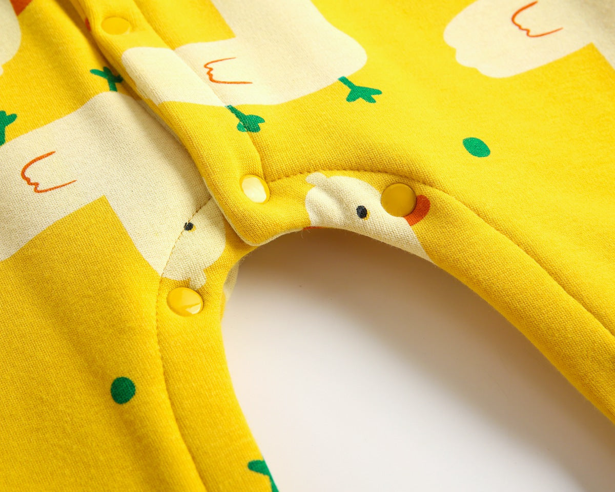 Baby wearing a cute cartoon duck print romper with matching hat, showcasing vibrant colors and playful design.