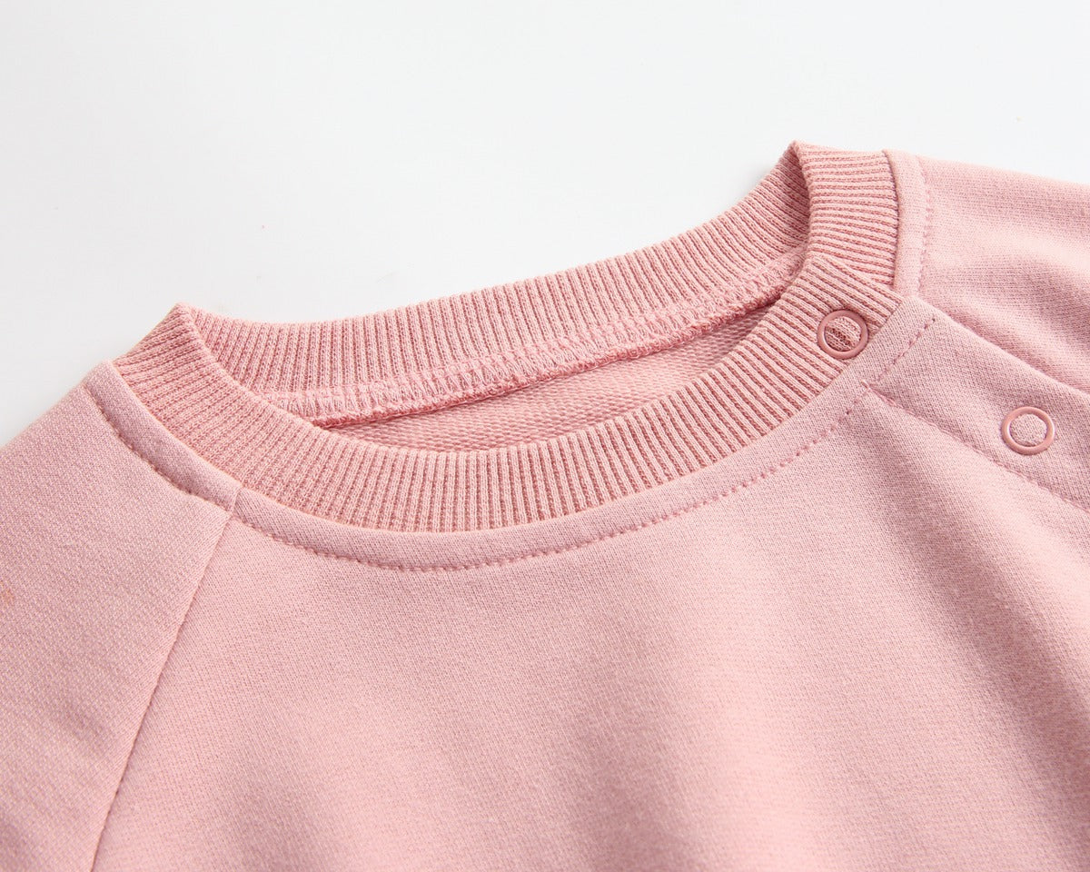 Baby wearing a long-sleeved cartoon print cotton onesie with a matching hat, showcasing a playful design in pink, grey, and brown colors.