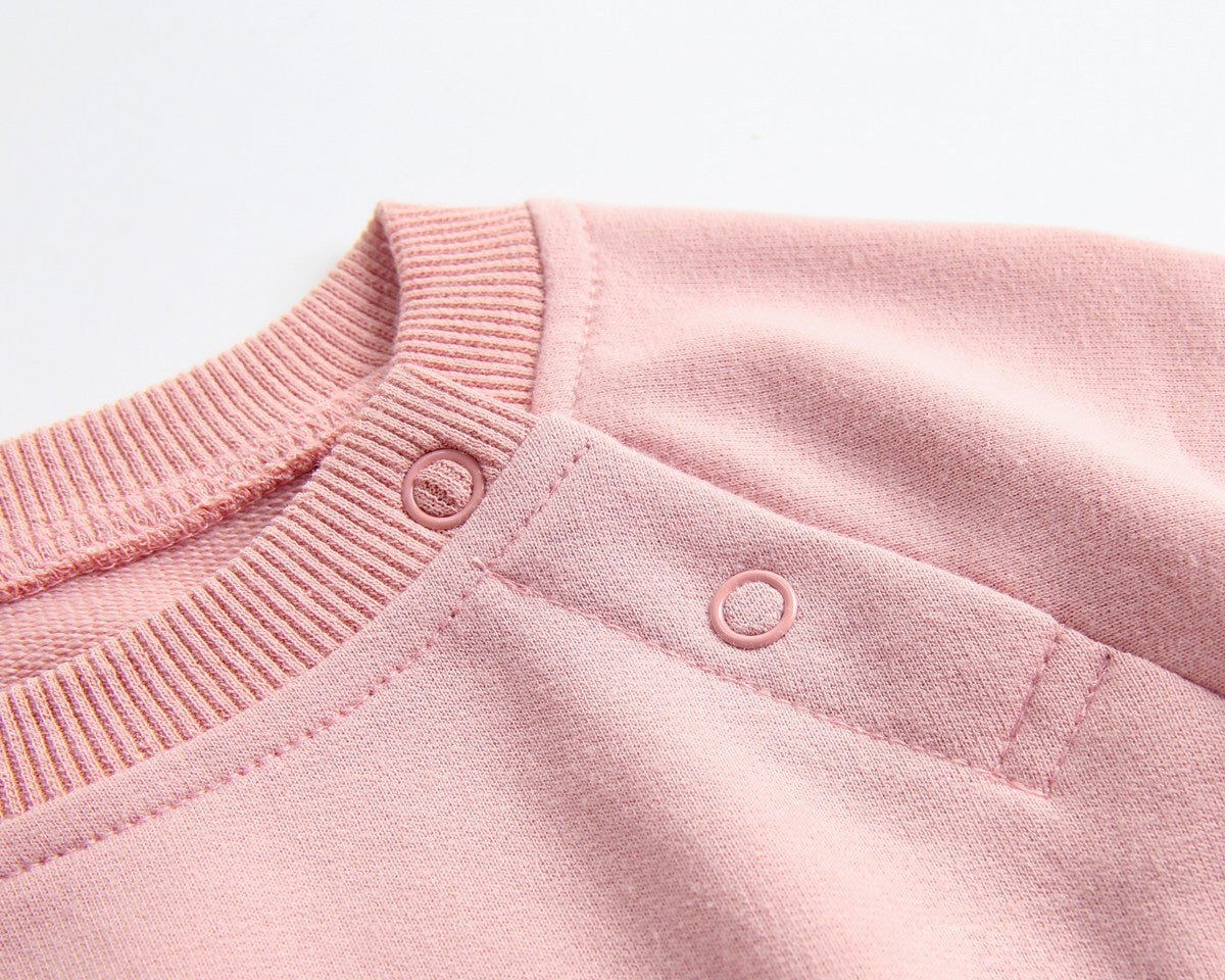 Baby wearing a long-sleeved cartoon print cotton onesie with a matching hat, showcasing a playful design in pink, grey, and brown colors.