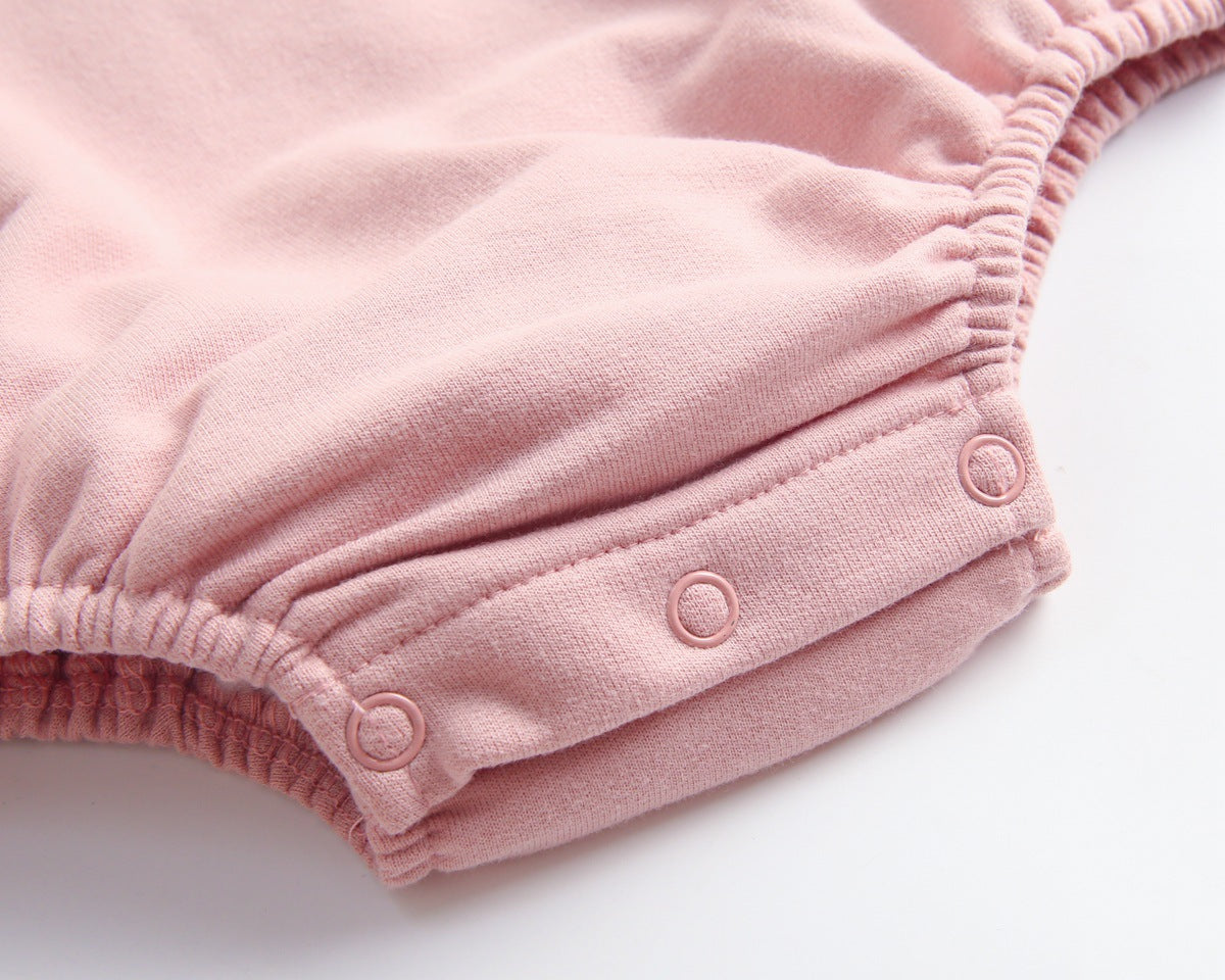 Baby wearing a long-sleeved cartoon print cotton onesie with a matching hat, showcasing a playful design in pink, grey, and brown colors.